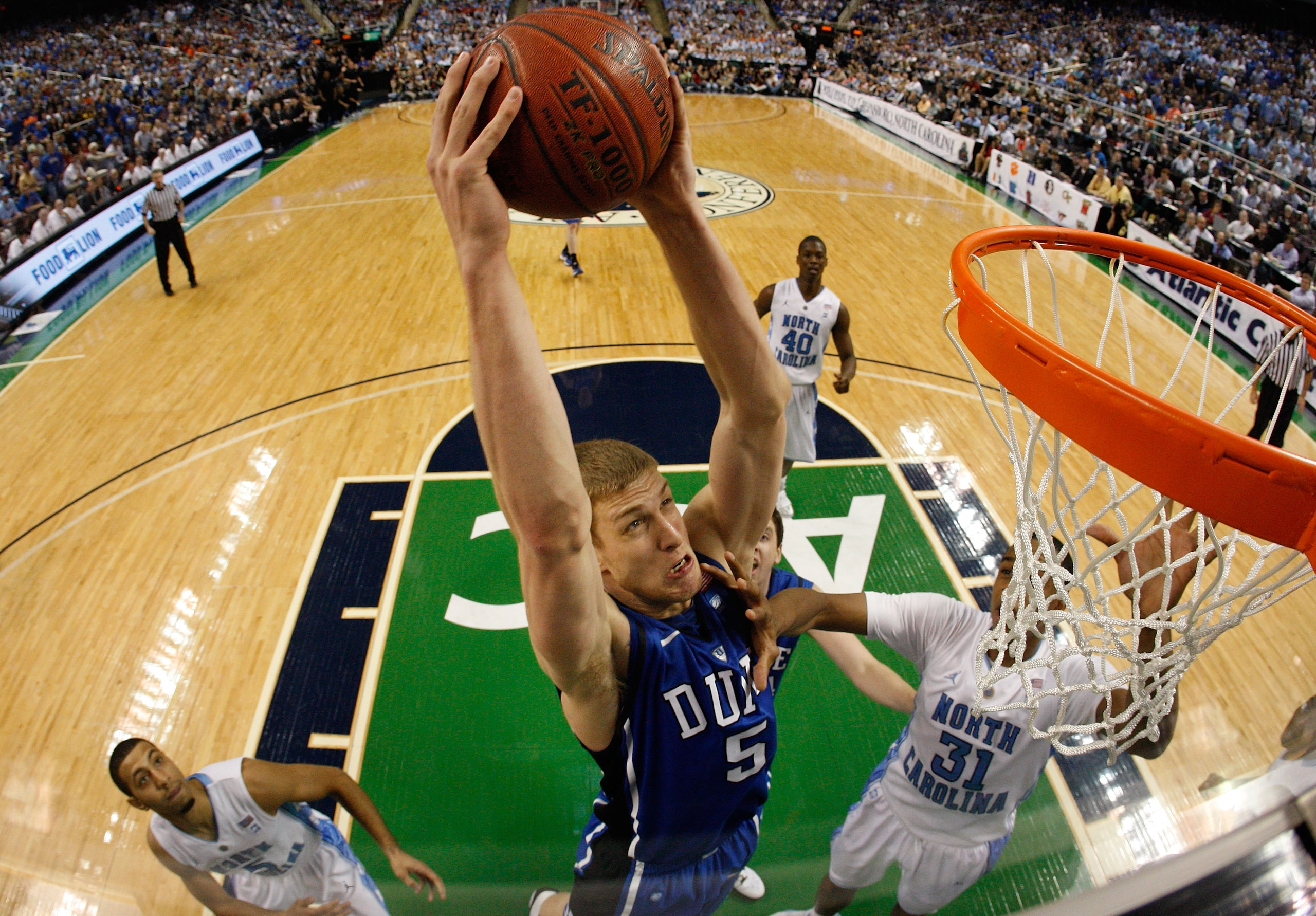 GREENSBORO, NC - MARCH 13:  Mason Plumlee #5 of the Duke Blue Devils shoots against John Henson #31 of the North Carolina Tar Heels in the championship game of the 2011 ACC men's basketball tournament at the Greensboro Coliseum on March 13, 2011 in Greens
