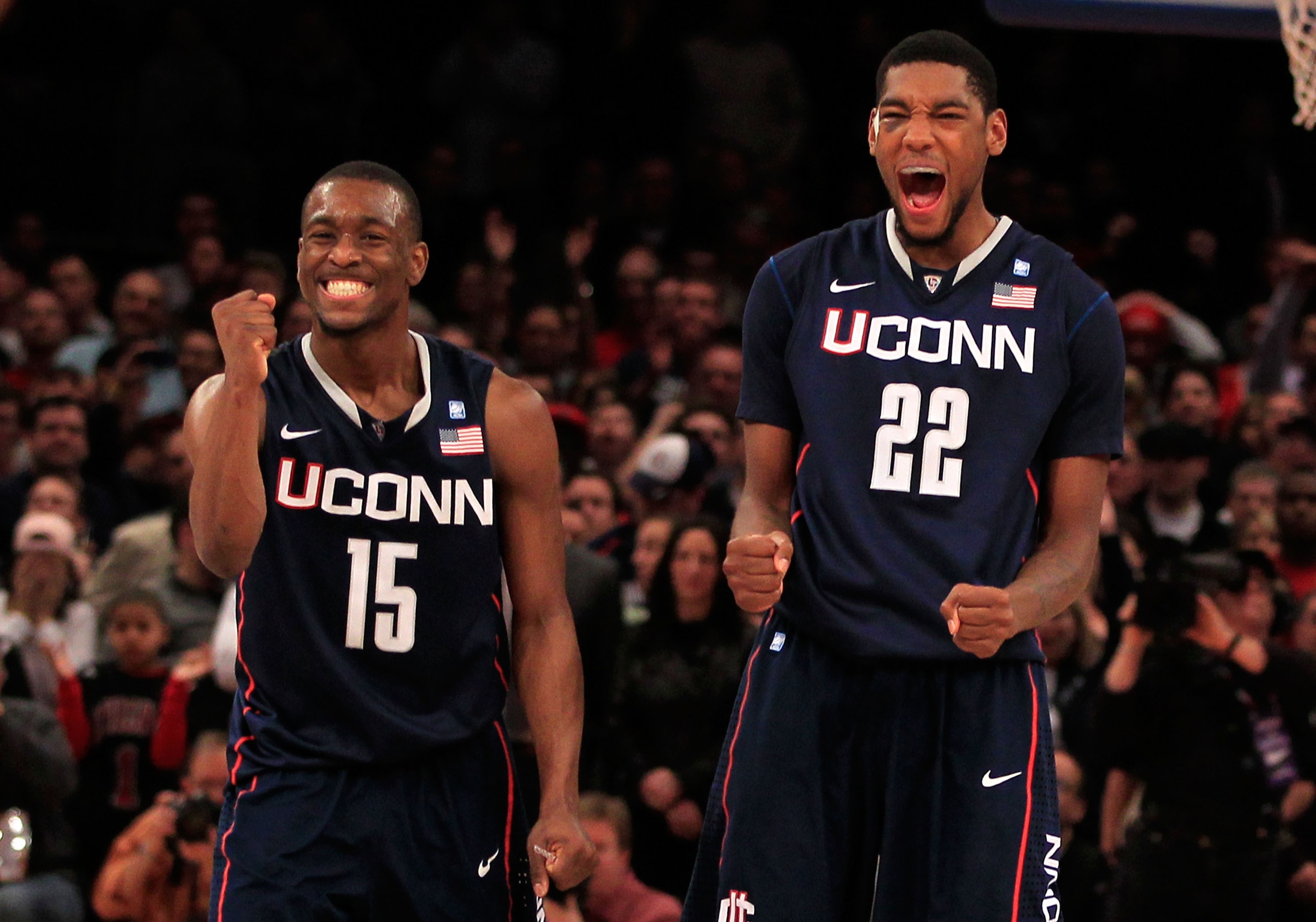 NEW YORK, NY - MARCH 12:  Kemba Walker #15 and Roscoe Smith #22 of the Connecticut Huskies celebrate late in the game against the Louisville Cardinals during the championship of the 2011 Big East Men's Basketball Tournament presented by American Eagle Out