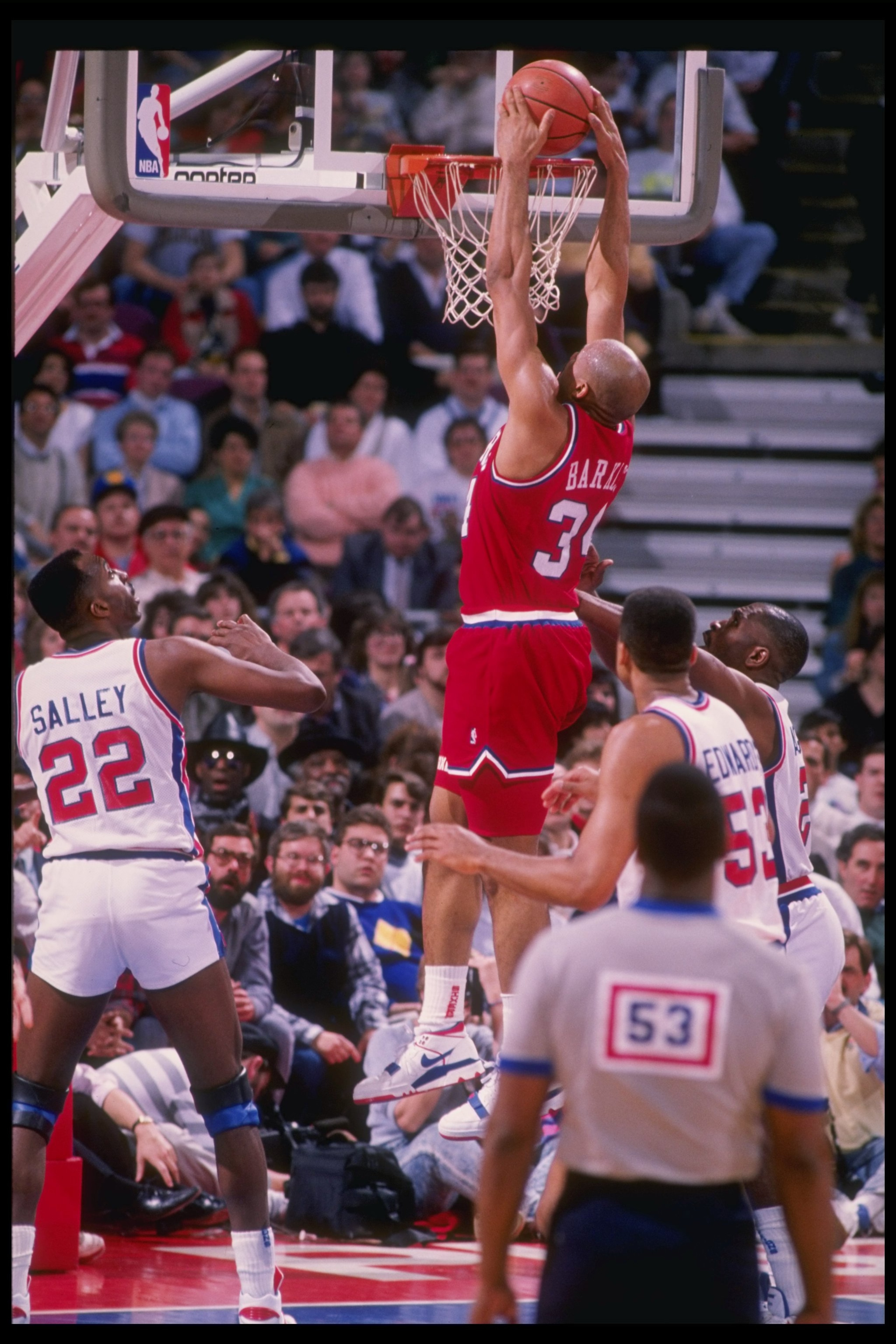 Forward Charles Barkley of the Philadelphia 76ers slam dunks during a game against the Detroit Pistons at The Palace of Auburn Hills in Auburn Hill, Michigan.
