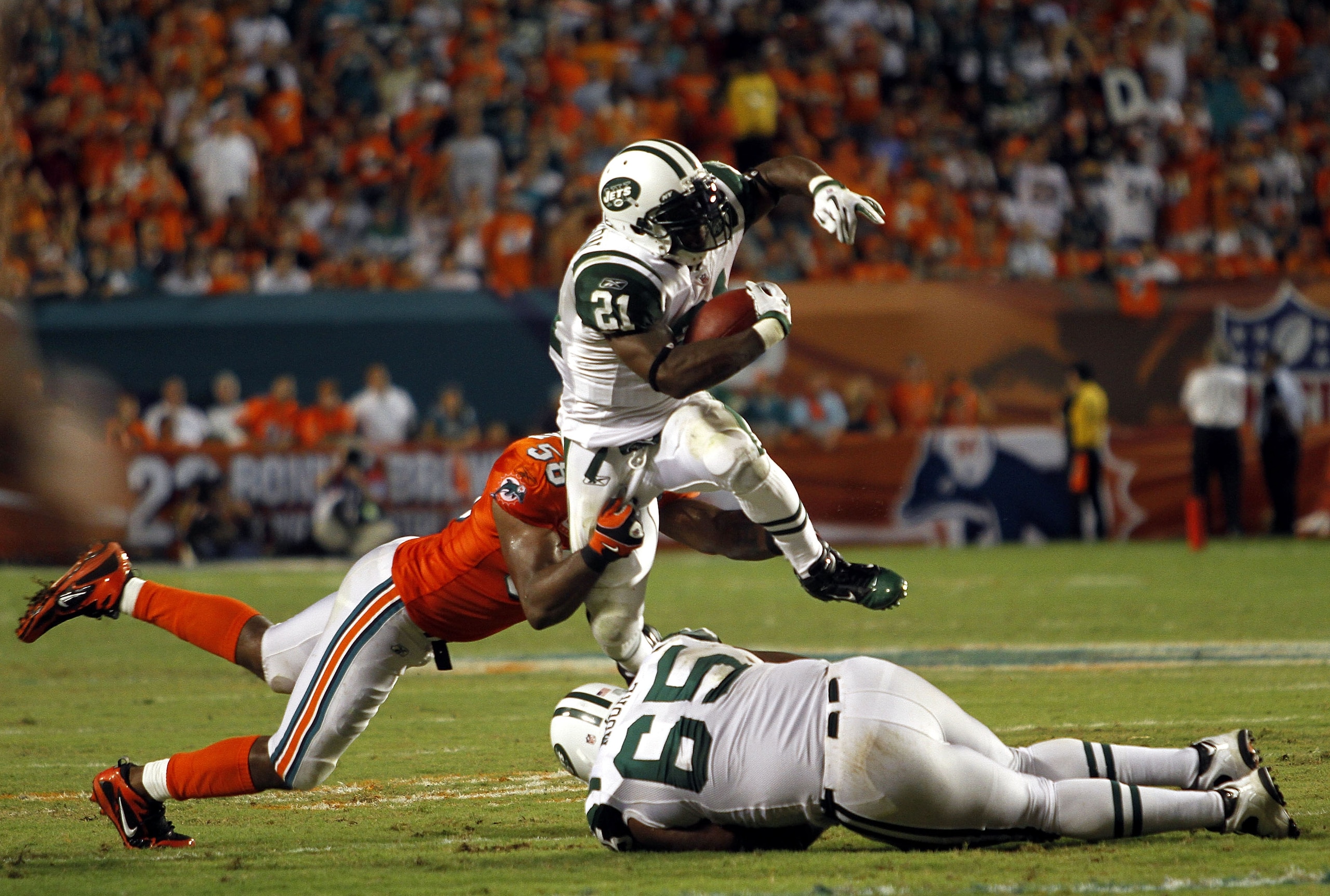 MIAMI - SEPTEMBER 26:  Running back LaDanian Tomlinson #21 of the New York Jets runs against the Miami Dolphins at Sun Life Stadium on September 26, 2010 in Miami, Florida.  (Photo by Marc Serota/Getty Images)
