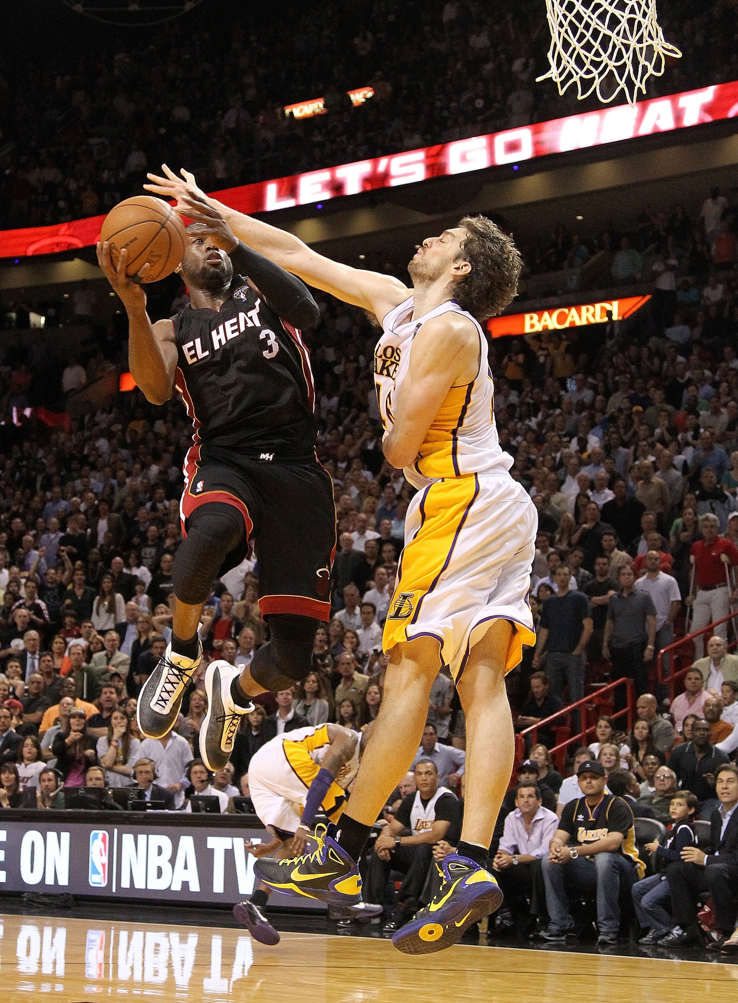 MIAMI, FL - MARCH 10:  Dwyane Wade #3 of the Miami Heat shoots over Pau Gasol #16 of  the Los Angeles Lakers  during a game at American Airlines Arena on March 10, 2011 in Miami, Florida. NOTE TO USER: User expressly acknowledges and agrees that, by downl