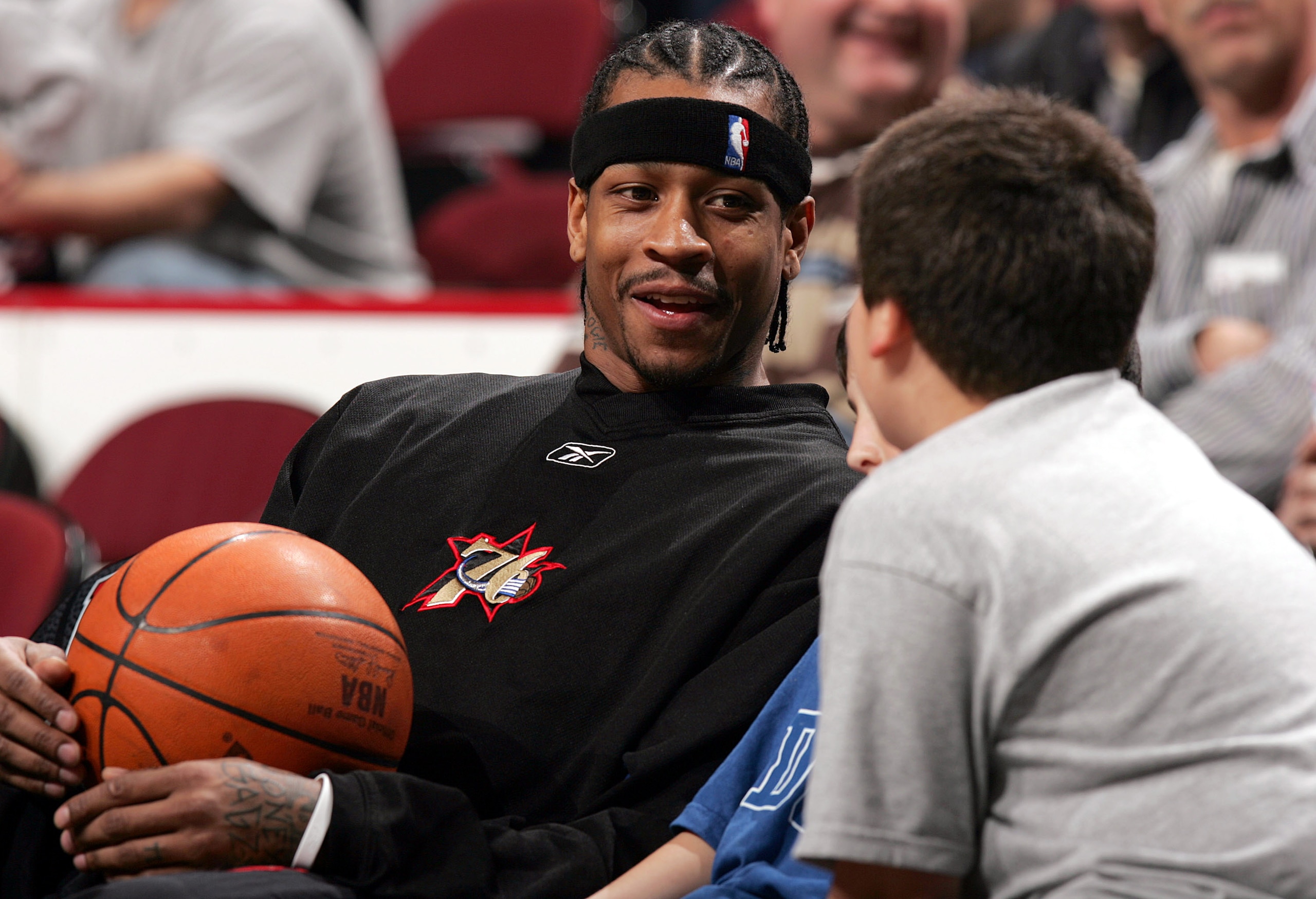 CHICAGO - JANUARY 12:  Allen Iverson #3 of the Philadelphia 76ers chats with two young fans during warm-ups before a game against the Chicago Bulls on January 12, 2005 at the United Center in Chicago, Illinois. The Bulls defeated the 76ers 110-78. NOTE TO