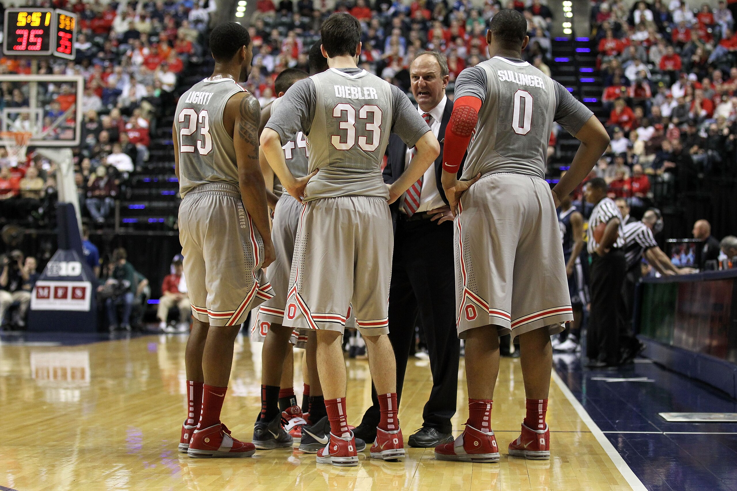 INDIANAPOLIS, IN - MARCH 13:  Head coach Thad Matta of the Ohio State Buckeyes talks with his players during a timeout including David Lighty #23, Jon Diebler #33 and Jared Sullinger #0 against the Penn State Nittany Lions during the championship game of