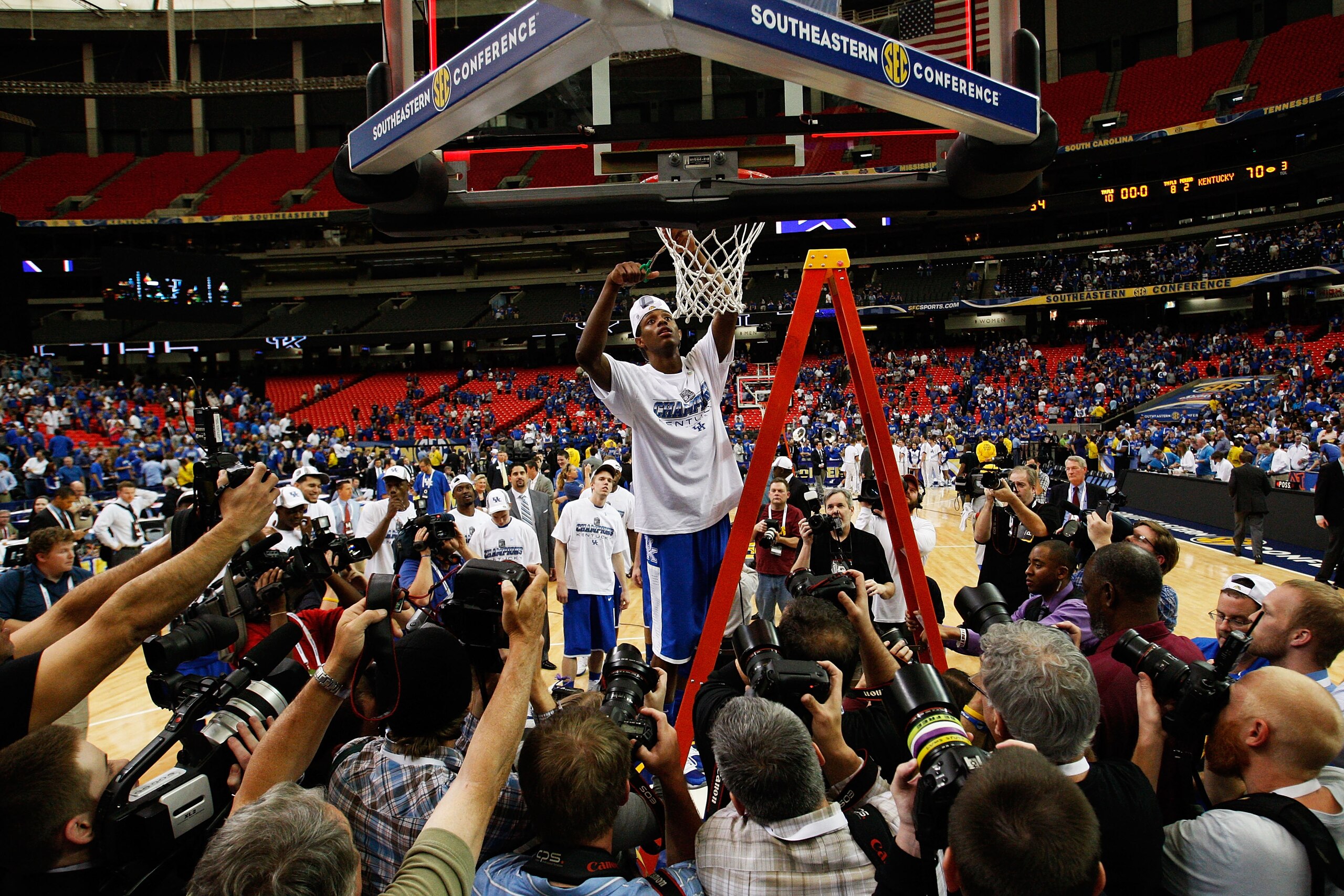 ATLANTA - MARCH 13: Deandre Liggins #34 of the Kentucky Wildcats cuts down the net after their 70 to 54 win over the Florida Gators in the championship game of the SEC Men's Basketball Tournament at Georgia Dome on March 13, 2011 in Atlanta, Georgia. (Pho