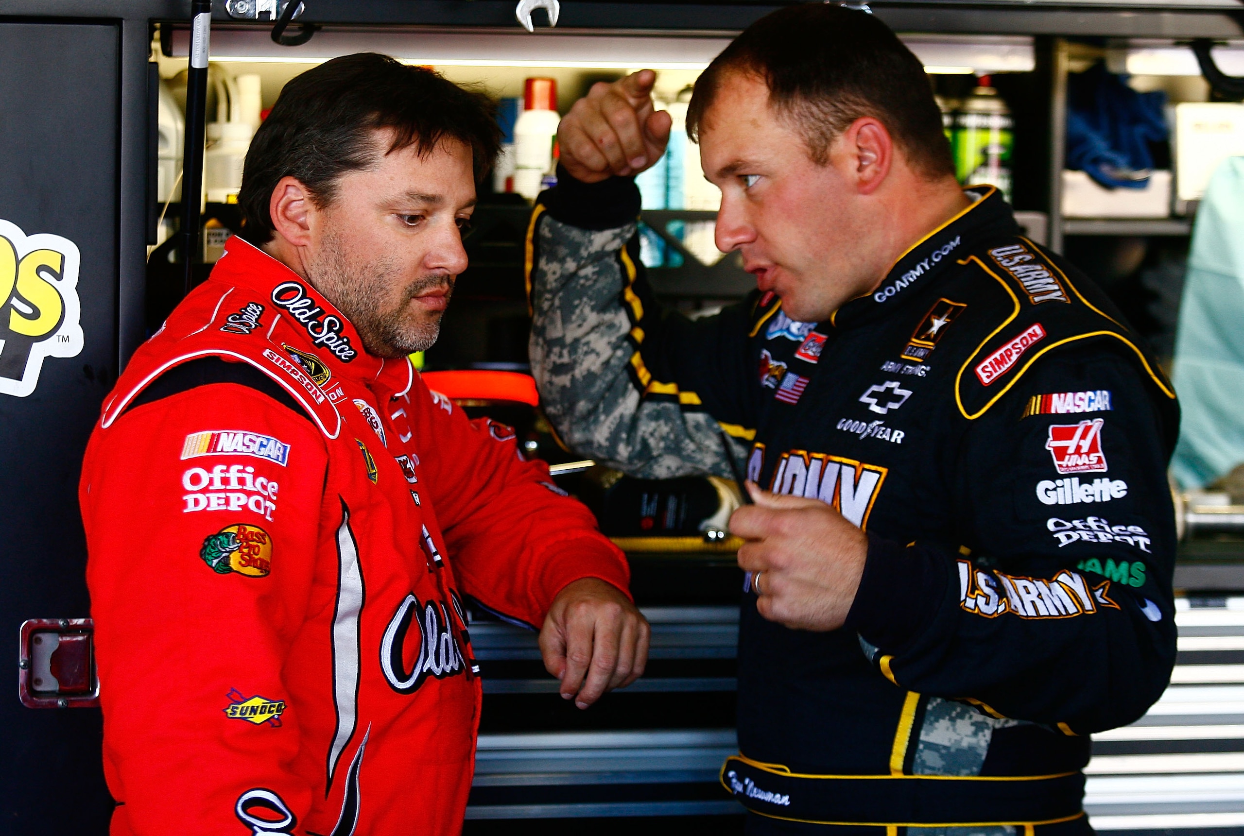 AVONDALE, AZ - NOVEMBER 12:  (L-R) Tony Stewart, driver of the #14 Old Spice/Office Depot Chevrolet, and Ryan Newman, driver of the #39 U.S. Army Chevrolet, speak in the garage area during practice for the NASCAR Sprint Cup Series Kobalt Tools 500 at Phoe