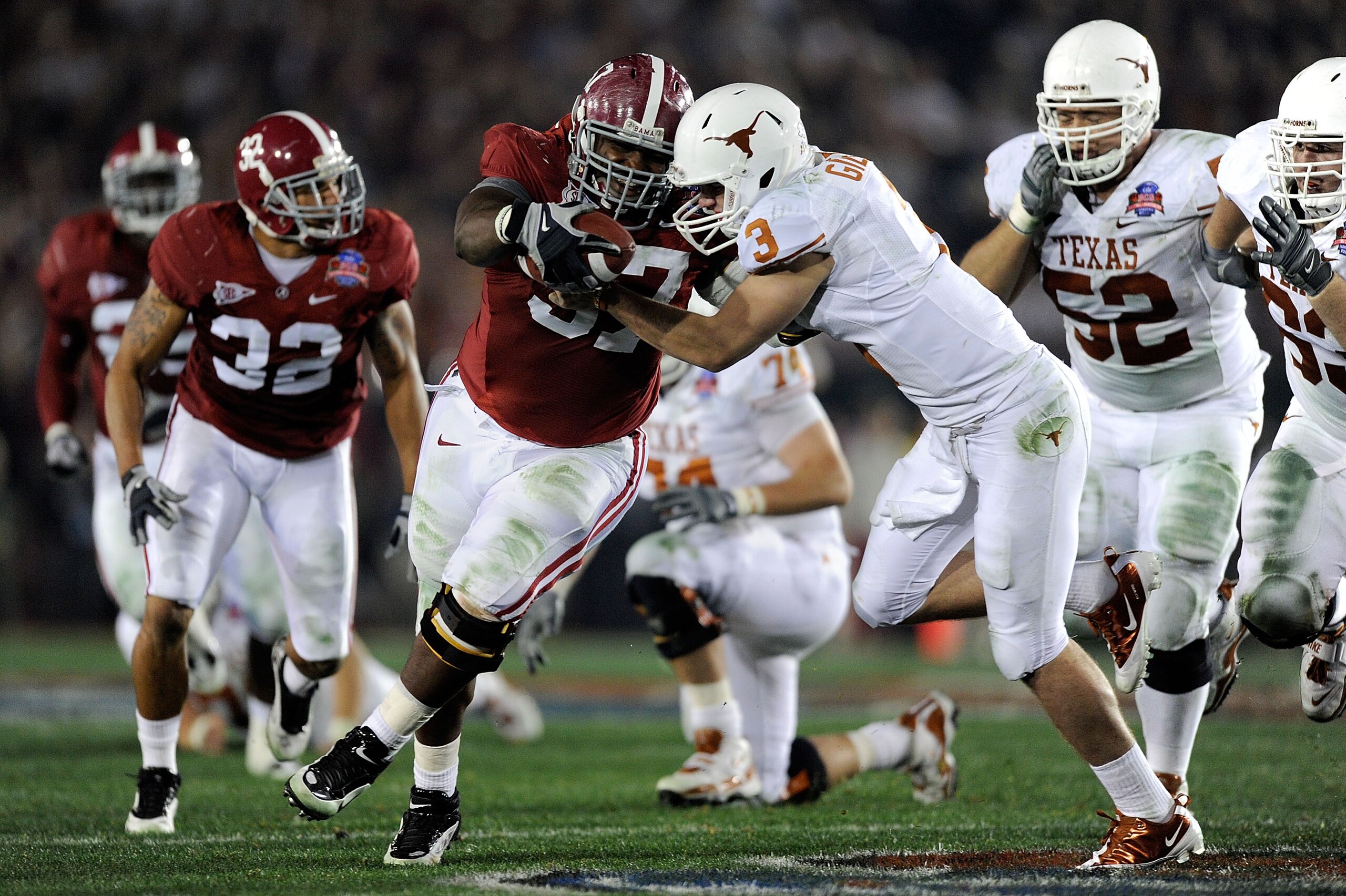 PASADENA, CA - JANUARY 07:  Quarterback Garrett Gilbert #3 of the Texas Longhorns tries to tackle lineman Marcell Dareus #57 of the Alabama Crimson Tide who would score after intercepting the ball during the second quarter of the Citi BCS National Champio