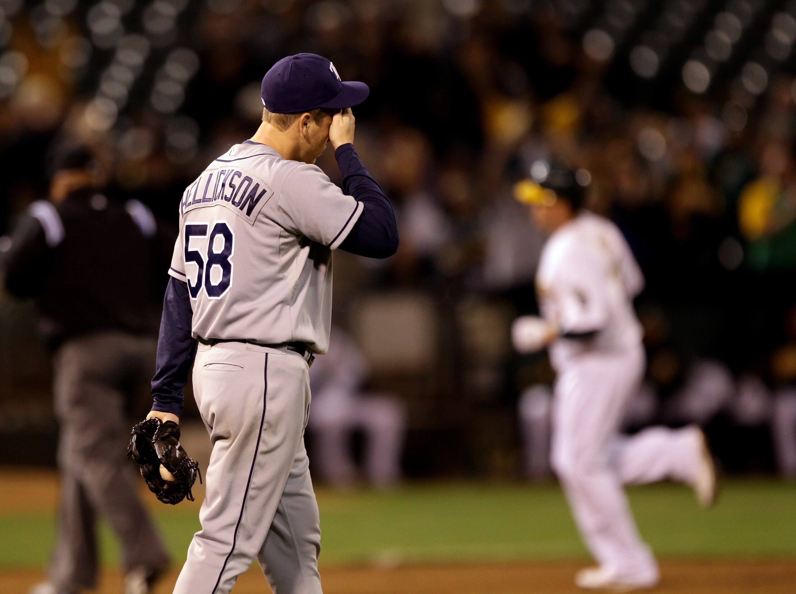 OAKLAND, CA - AUGUST 20:  Jeremy Hellickson #58 of the Tampa Bay Rays reacts while Jack Cust #32 of the Oakland Athletics rounds the bases after he hit a home run to tie the game 3-3 in the sixth inning at the Oakland-Alameda County Coliseum  on August 20