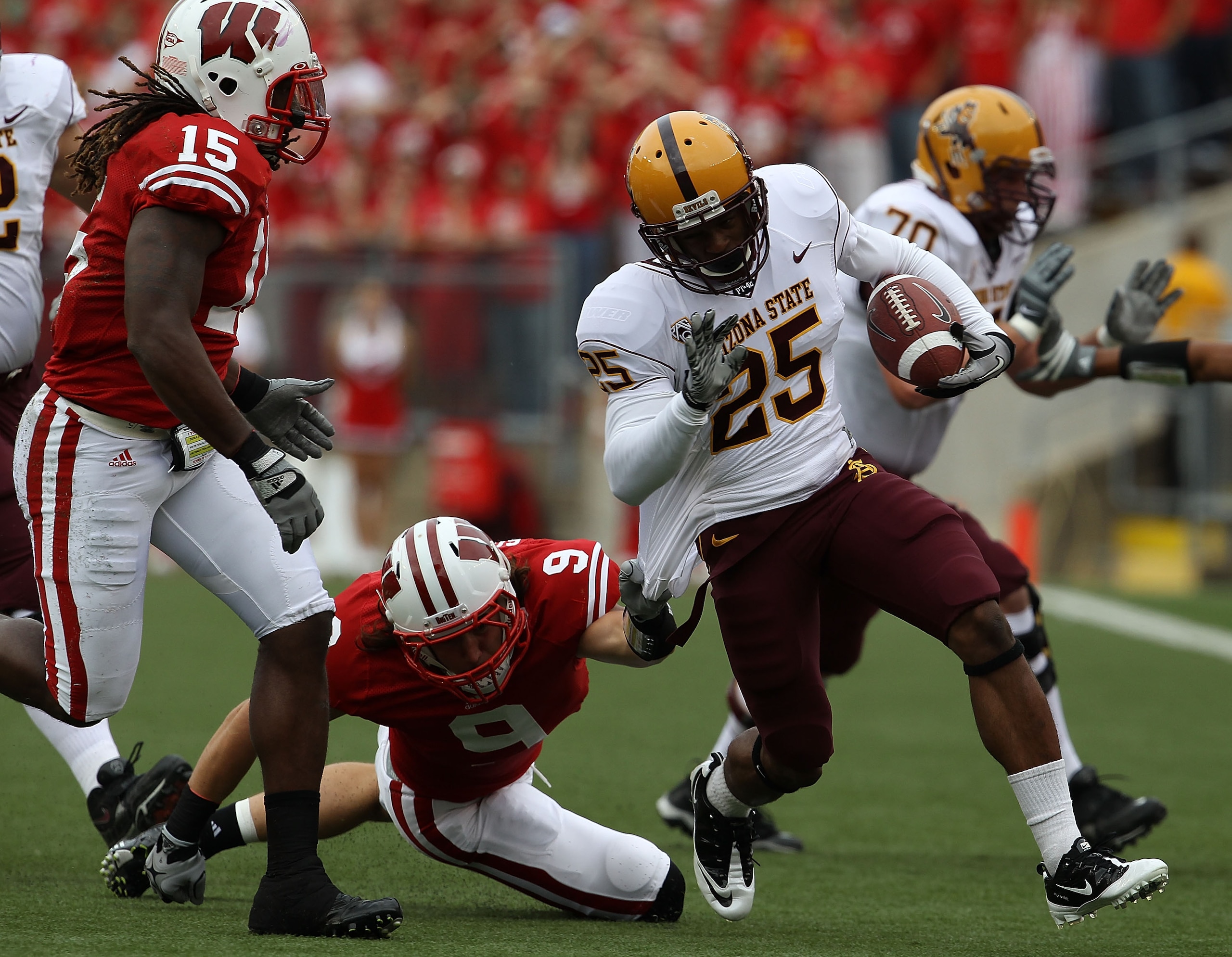 MADISON, WI - SEPTEMBER 18: Deantre Lewis #25 of the Arizona State Sun Devils tries to break away from Blake Sorensen #9 of the Wisconsin Badgers as Culmer St. Jean #15 closes in at Camp Randall Stadium on September 18, 2010 in Madison, Wisconsin. Wiscons