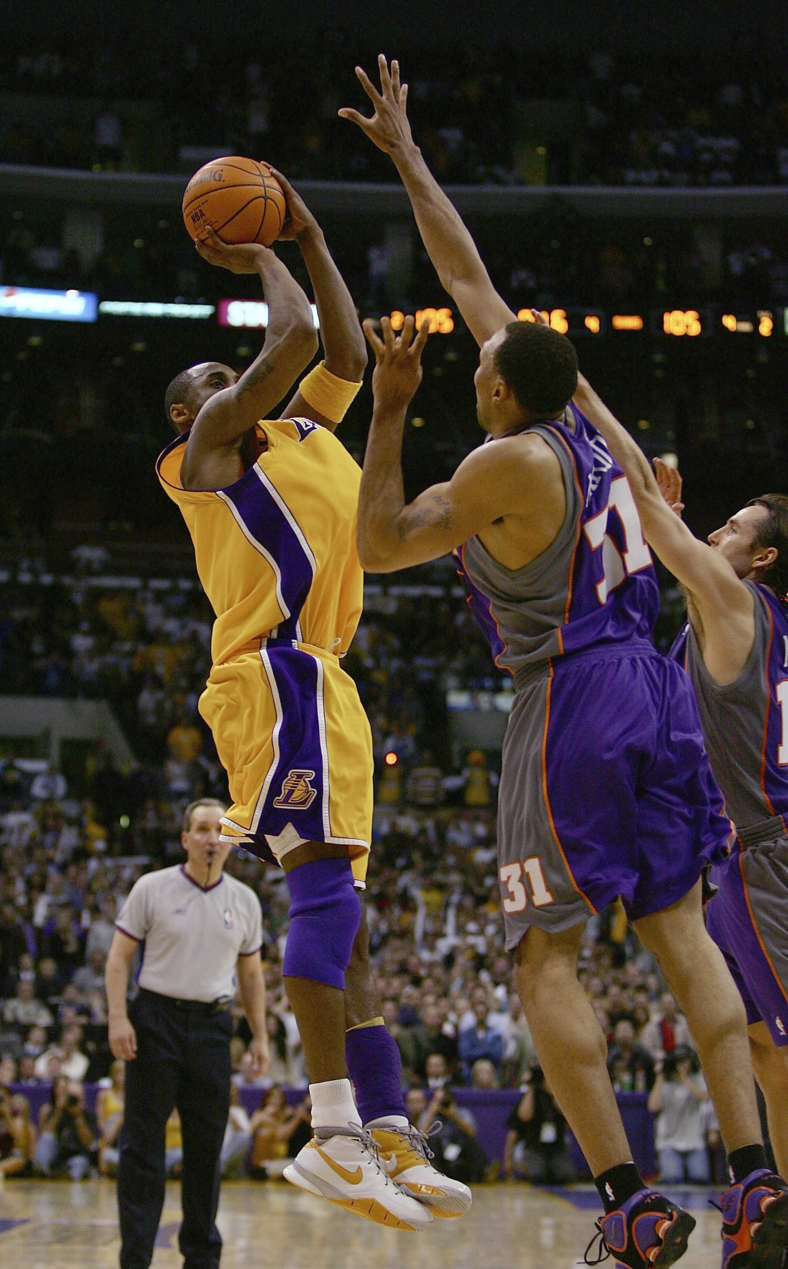 LOS ANGELES - MAY 4:  Kobe Bryant #8 of the Los Angeles Lakers goes up for a shot in the final seconds of regulation over Shawn Marion #31 and Steve Nash #13 of the Phoenix Suns in game six of the Western Conference Quarterfinals during the 2006 NBA Playo