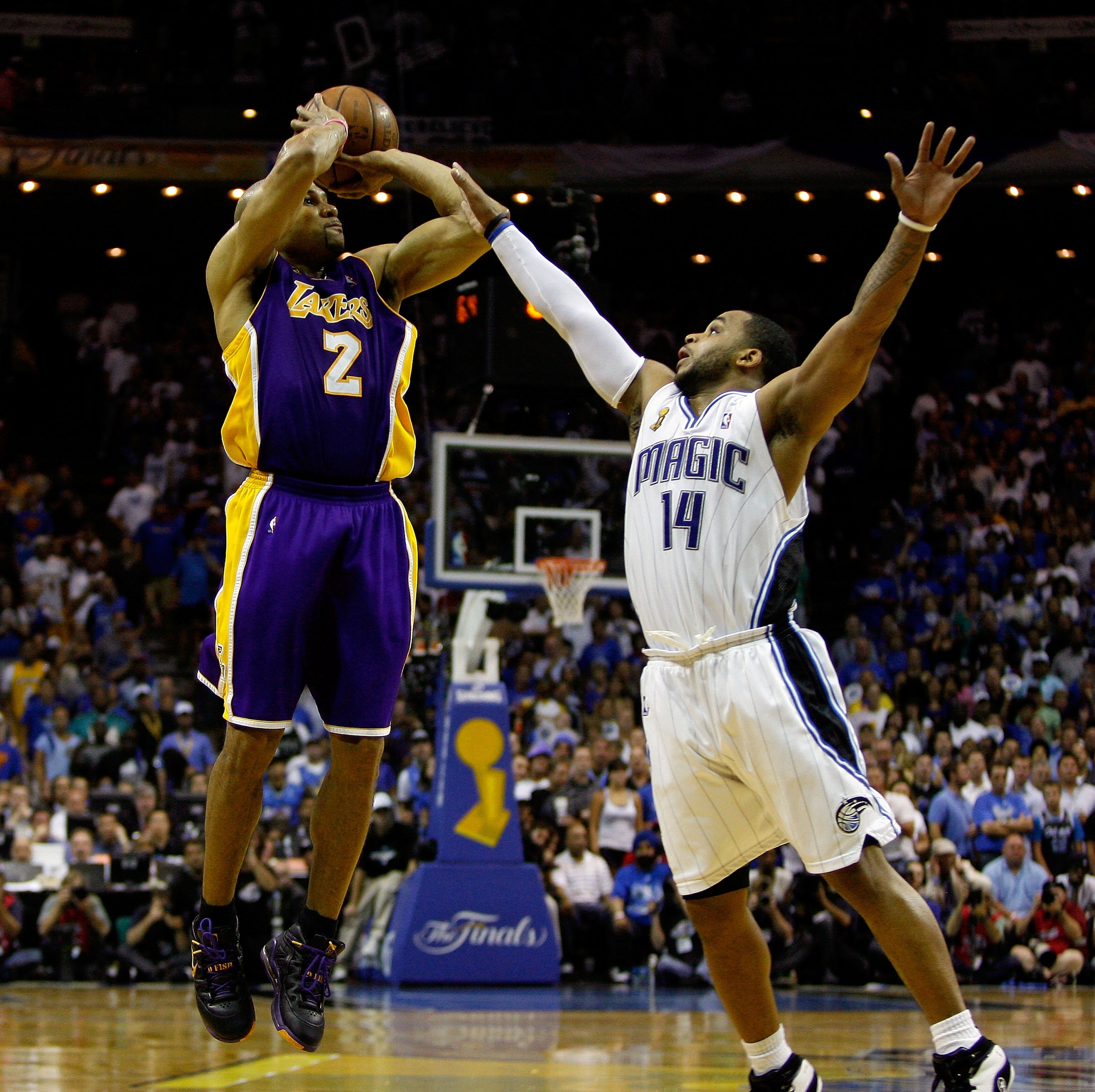 ORLANDO, FL - JUNE 11:  Derek Fisher #2 of the Los Angeles Lakers shoots a game-tying three-point shot over Jameer Nelson #14 of the Orlando Magic in the fourth quarter of Game Four of the 2009 NBA Finals on June 11, 2009 at Amway Arena in Orlando, Florid