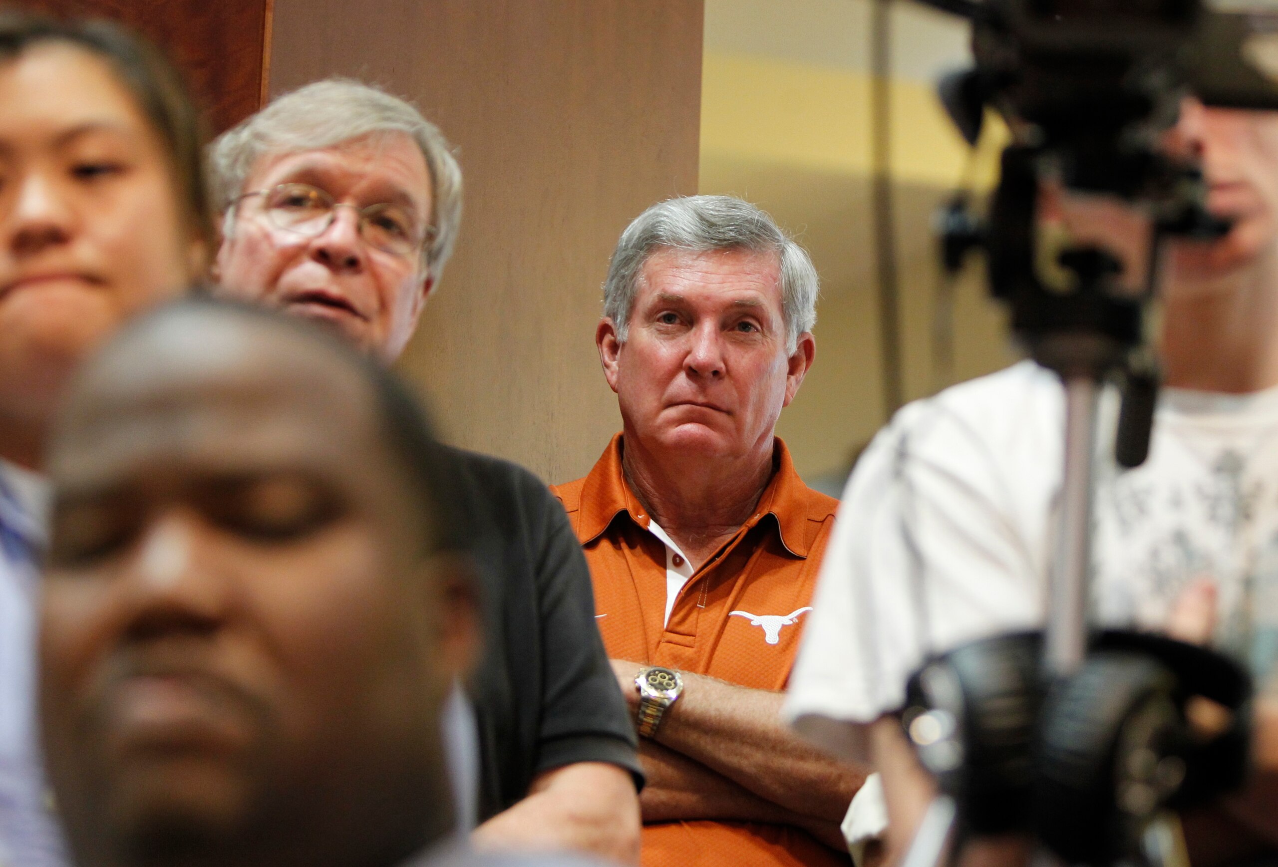 AUSTIN, TX - JUNE 15: University of Texas at Austin football head coach Mack Brown listens as university officials announce the athletics programs will continue competing in the Big 12 Conference June 15, 2010 in Austin, Texas. (Photo by Erich Schlegel/ AUSTIN, TX - JUNE 15: University of Texas at Austin football head coach Mack Brown listens as university officials announce the athletics programs will continue competing in the Big 12 Conference June 15, 2010 in Austin, Texas. (Photo by Erich Schlegel/