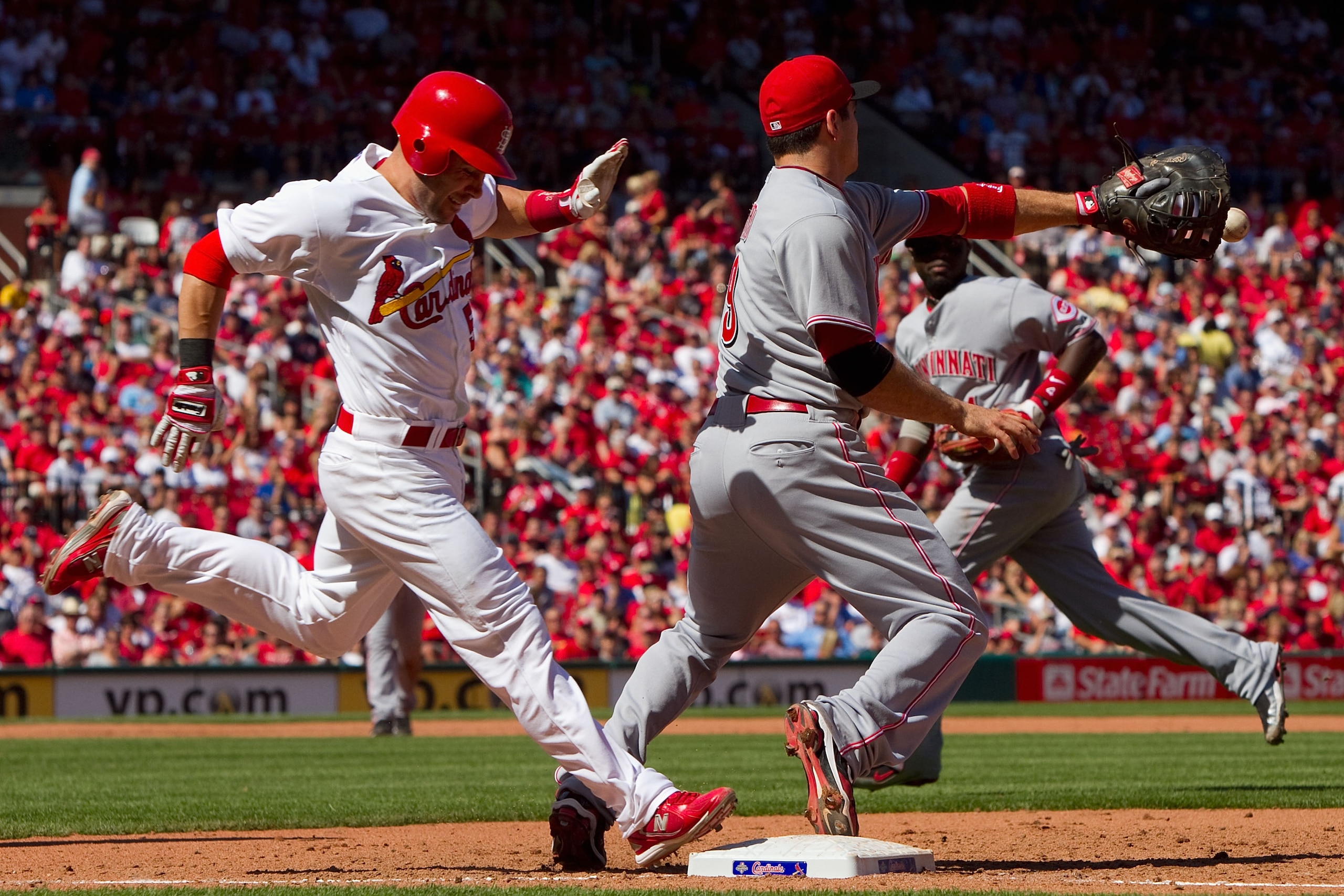 ST. LOUIS - SEPTEMBER 5: Skip Schumaker #55 of the St. Louis Cardinals is thrown out at first base against the Cincinnati Reds at Busch Stadium on September 5, 2010 in St. Louis, Missouri.  The Cardinals beat the Reds 4-2.  (Photo by Dilip Vishwanat/Getty