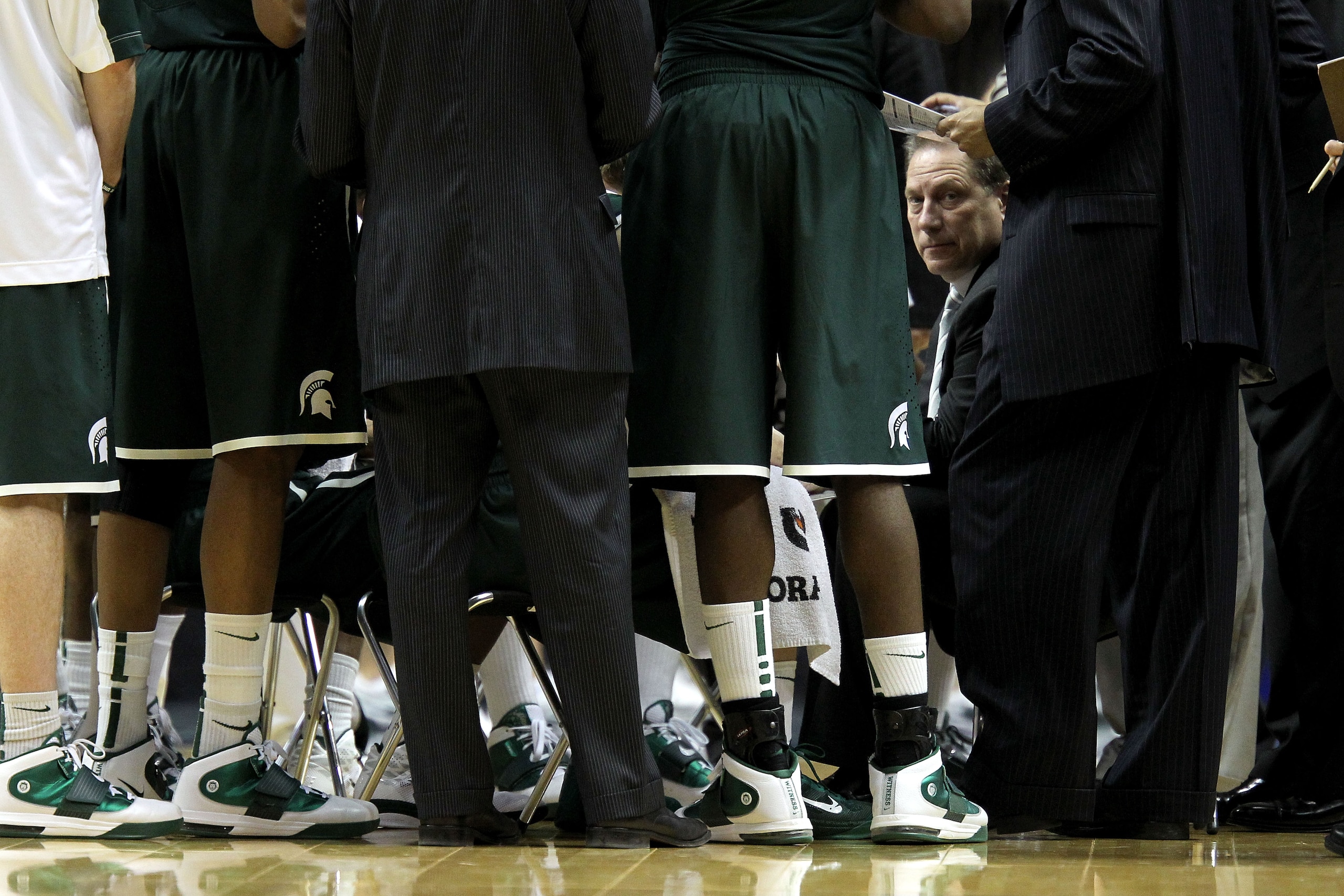 INDIANAPOLIS, IN - MARCH 12:  Head coach Tom Izzo of the Michigan State Spartans talks with his players during a timeout against the Penn State Nittany Lions during the semifinals of the 2011 Big Ten Men's Basketball Tournament at Conseco Fieldhouse on Ma