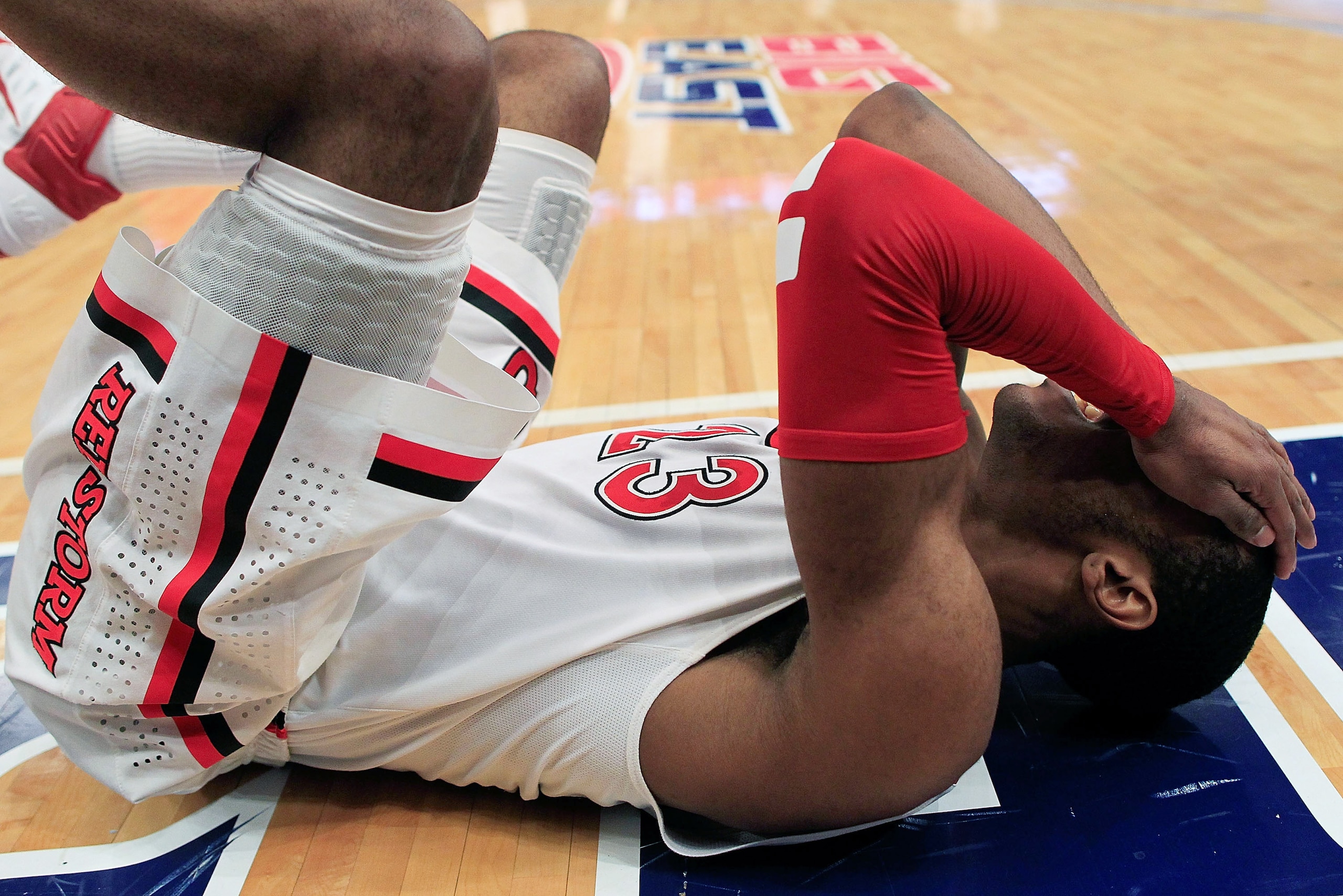 NEW YORK, NY - MARCH 09:  Paris Horne #23 of the St.Johns Red Storm falls to the floor during the game against the Rutgers Scarlet Knights during the second round of the 2011 Big East Men's Basketball Tournament presented by American Eagle Outfitters at M