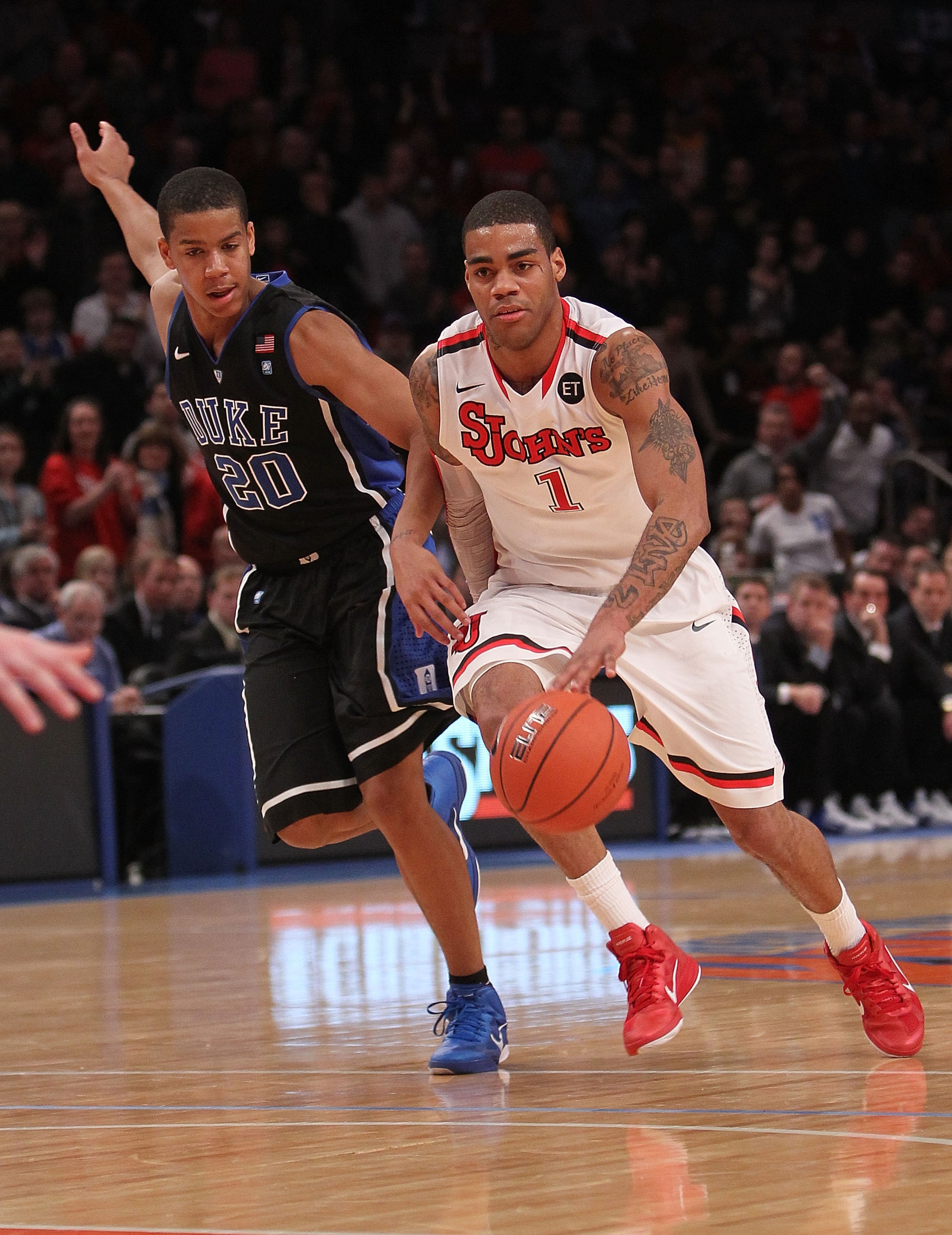 NEW YORK, NY - JANUARY 30:  D.J. Kennedy #1 of the St. John's Red Storm dribbles the ball past Andre Dawkins #20 of the Duke Blue Devils  at Madison Square Garden on January 30, 2011 in New York City.  (Photo by Nick Laham/Getty Images)