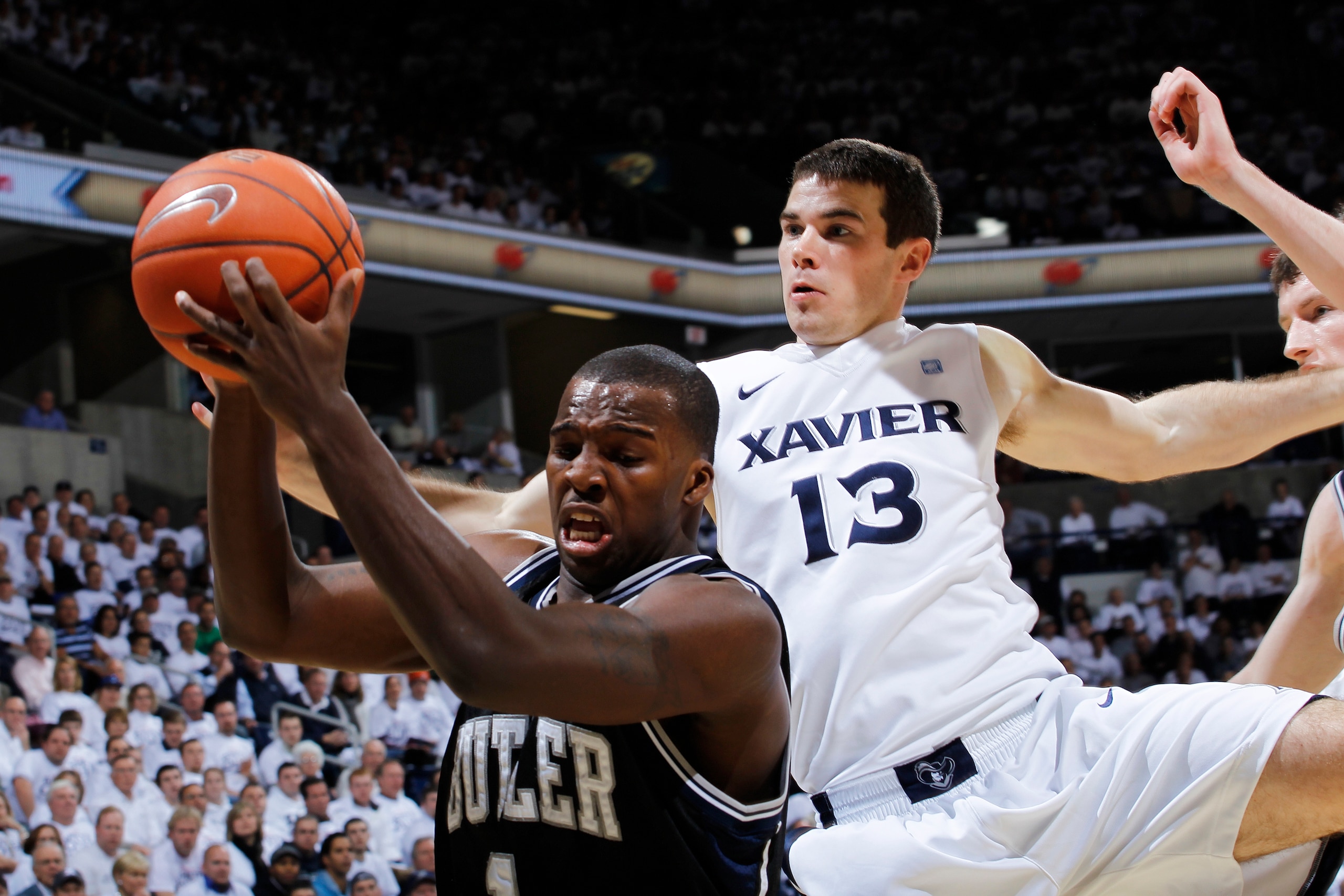 CINCINNATI, OH - DECEMBER 9: Shelvin Mack #1 of the Butler Bulldogs pulls a rebound away from Kevin Feeney #13 of the Xavier Musketeers at Cintas Center on December 9, 2010 in Cincinnati, Ohio. (Photo by Joe Robbins/Getty Images)