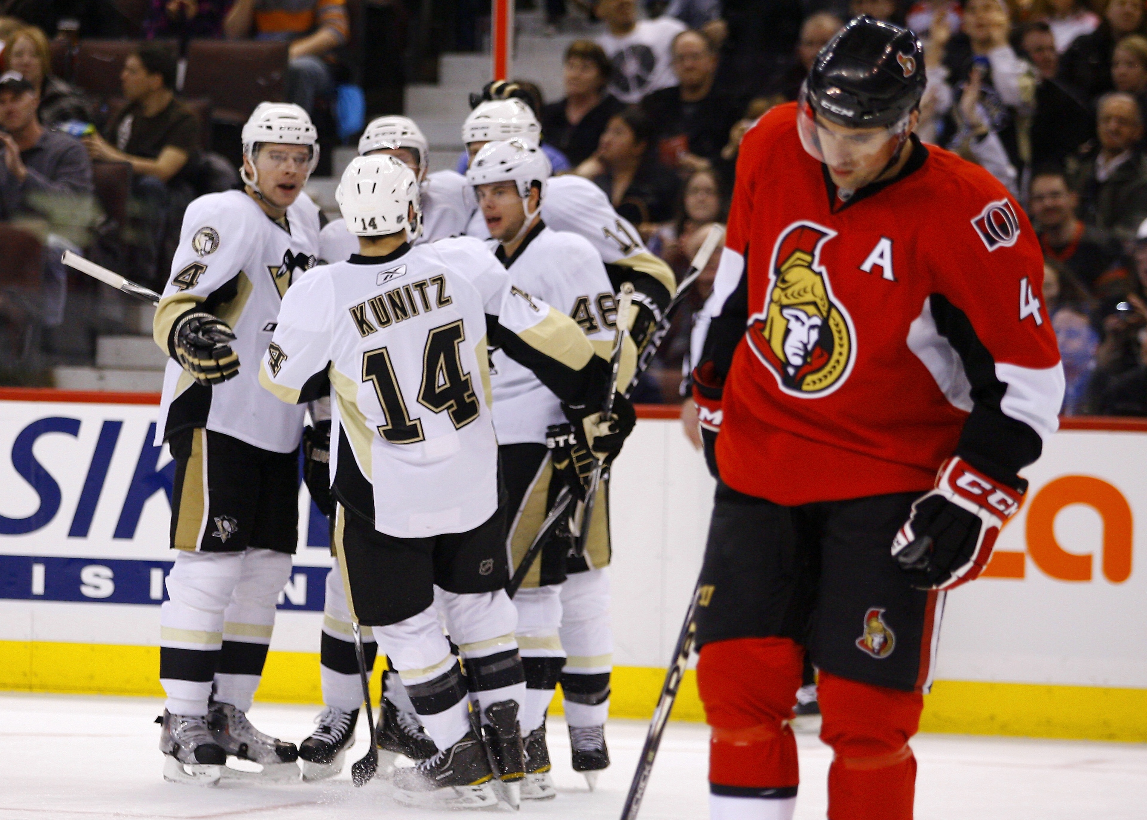 OTTAWA, CANADA - MARCH 15:  Zbynek Michalek #4;Chris Kunitz #14;Tyler Kennedy #48 and Jordan Staal #11 of the Pittsburgh Penguins celebrate a goal while Chris Phillips #4 of the Ottawa Senators skates away dejectedly in a game at Scotiabank Place on March