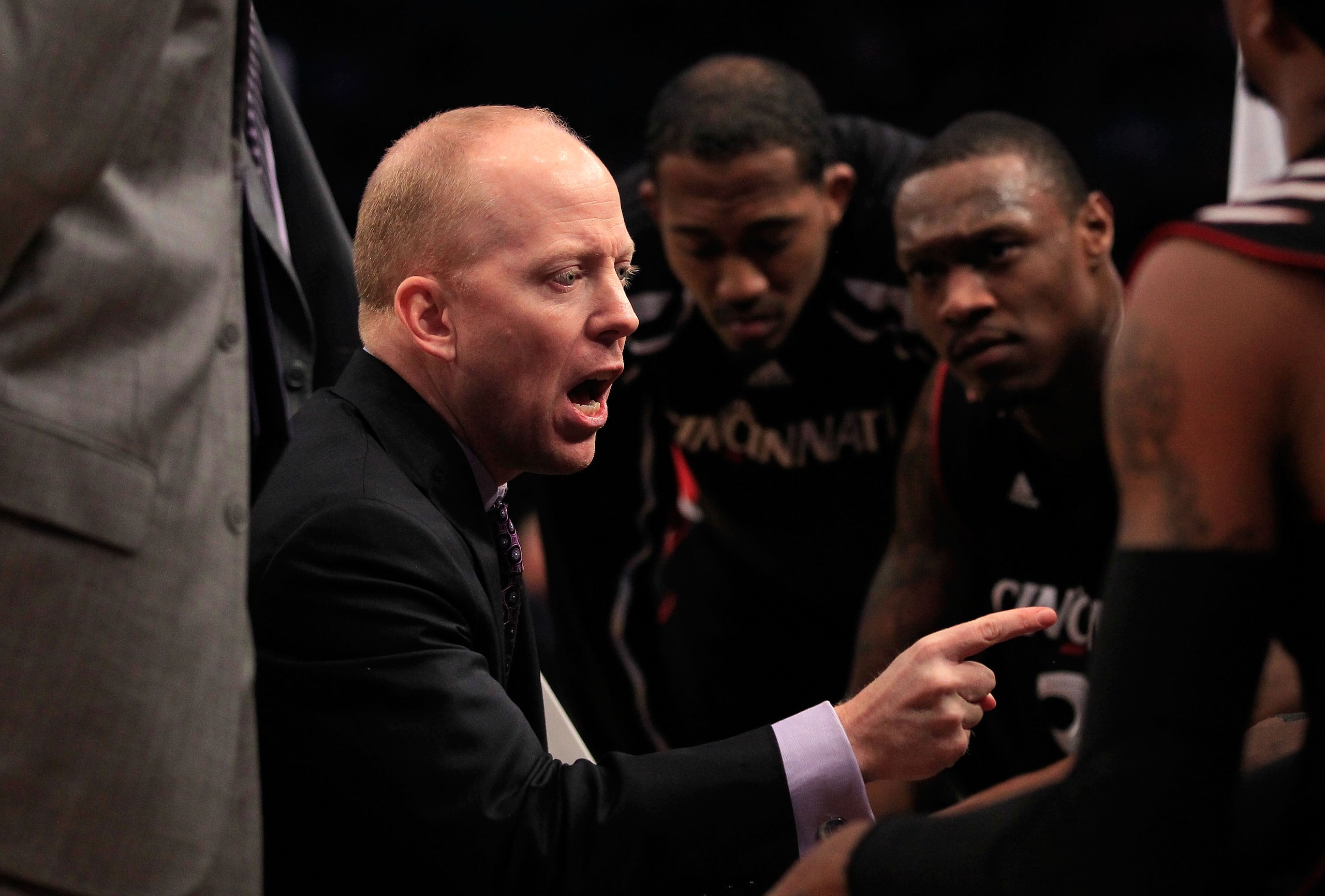 NEW YORK, NY - MARCH 10: Head coach Mick Cronin of the Cincinnati Bearcats speaks to players during a time out in the first half against the Notre Dame Fighting Irish during the quarterfinals of the 2011 Big East Men's Basketball Tournament presented by A NEW YORK, NY - MARCH 10: Head coach Mick Cronin of the Cincinnati Bearcats speaks to players during a time out in the first half against the Notre Dame Fighting Irish during the quarterfinals of the 2011 Big East Men's Basketball Tournament presented by A
