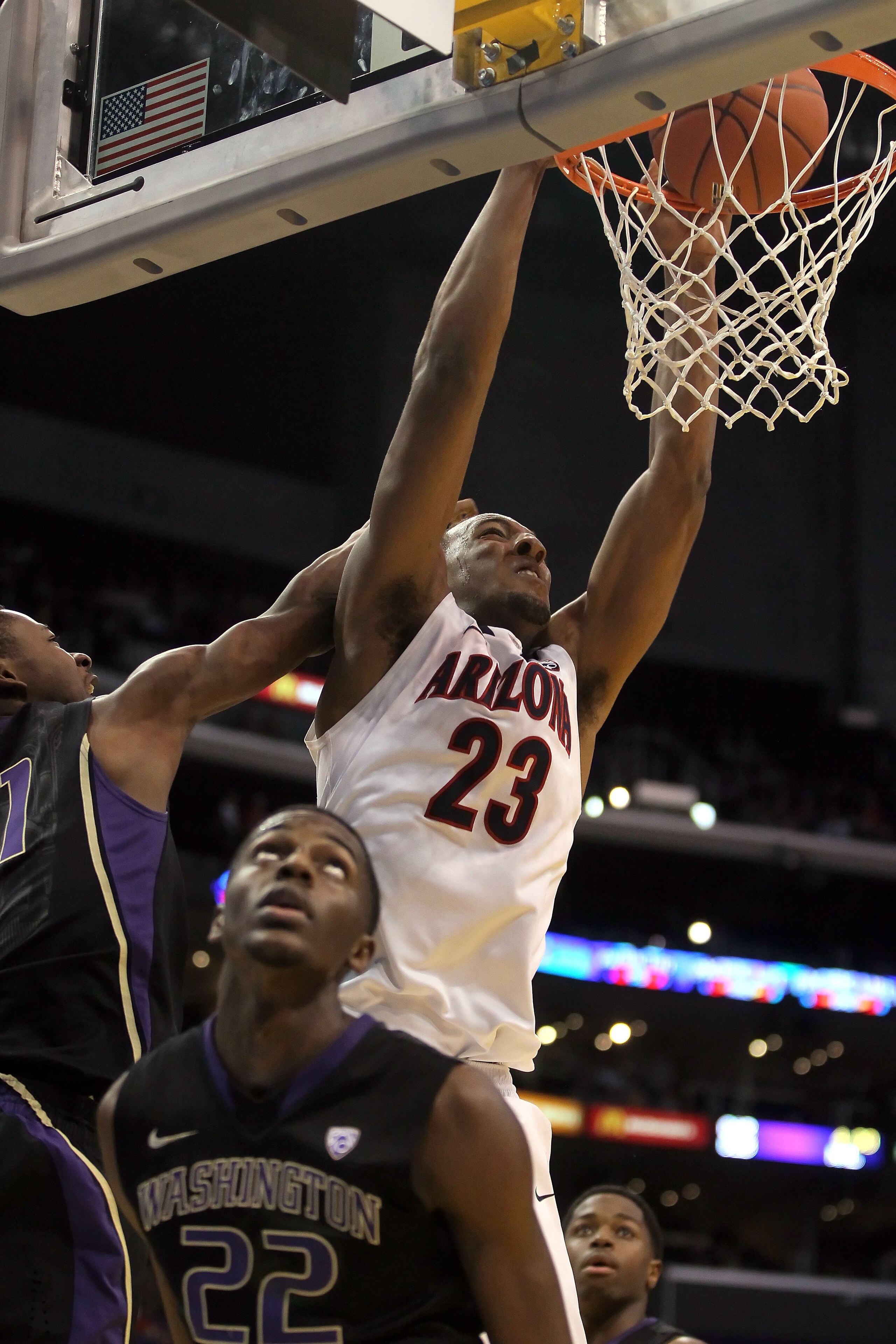 LOS ANGELES, CA - MARCH 12: Derrick Williams #23 of the Arizona Wildcats dunks the ball between Terrence Ross #31 and Justin Holiday #22 of the Washington Huskies in the first half in the championship game of the 2011 Pacific Life Pac-10 Men's Basketball LOS ANGELES, CA - MARCH 12: Derrick Williams #23 of the Arizona Wildcats dunks the ball between Terrence Ross #31 and Justin Holiday #22 of the Washington Huskies in the first half in the championship game of the 2011 Pacific Life Pac-10 Men's Basketball