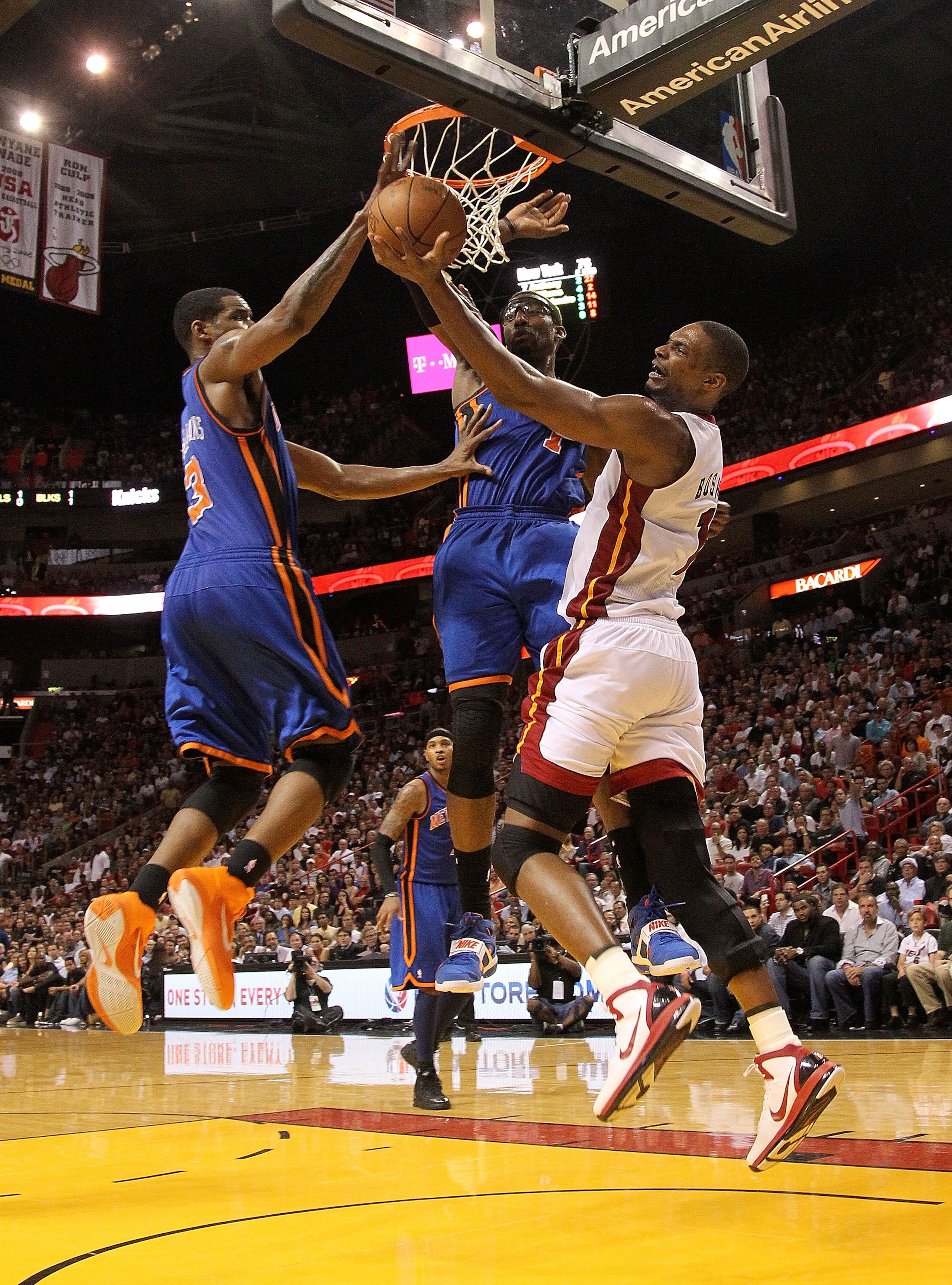 MIAMI, FL - FEBRUARY 27:  Chris Bosh #1 of the Miami Heat goes to the net against Amar'e Stoudemire #1 and Shawne Williams #3 of the New York Knicks during a game at American Airlines Arena on February 27, 2011 in Miami, Florida. NOTE TO USER: User expres