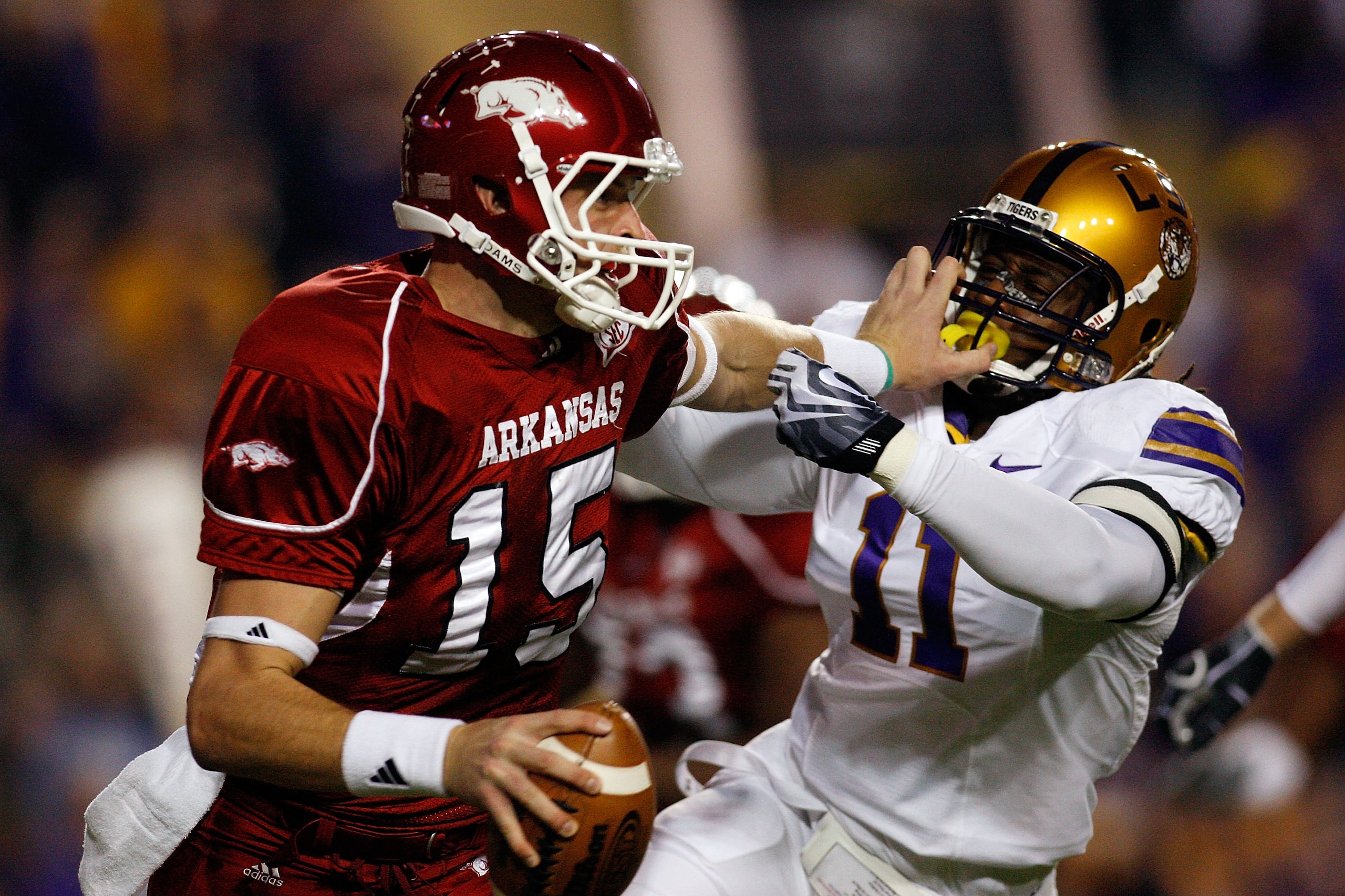 BATON ROUGE, LA - NOVEMBER 28:  Quarterback Ryan Mallett #15 of the Arkansas Razorbacks avoids a tackle by Kelvin Sheppard #11 of the Louisiana State University Tigers at Tiger Stadium on November 28, 2009 in Baton Rouge, Louisiana.  (Photo by Chris Grayt