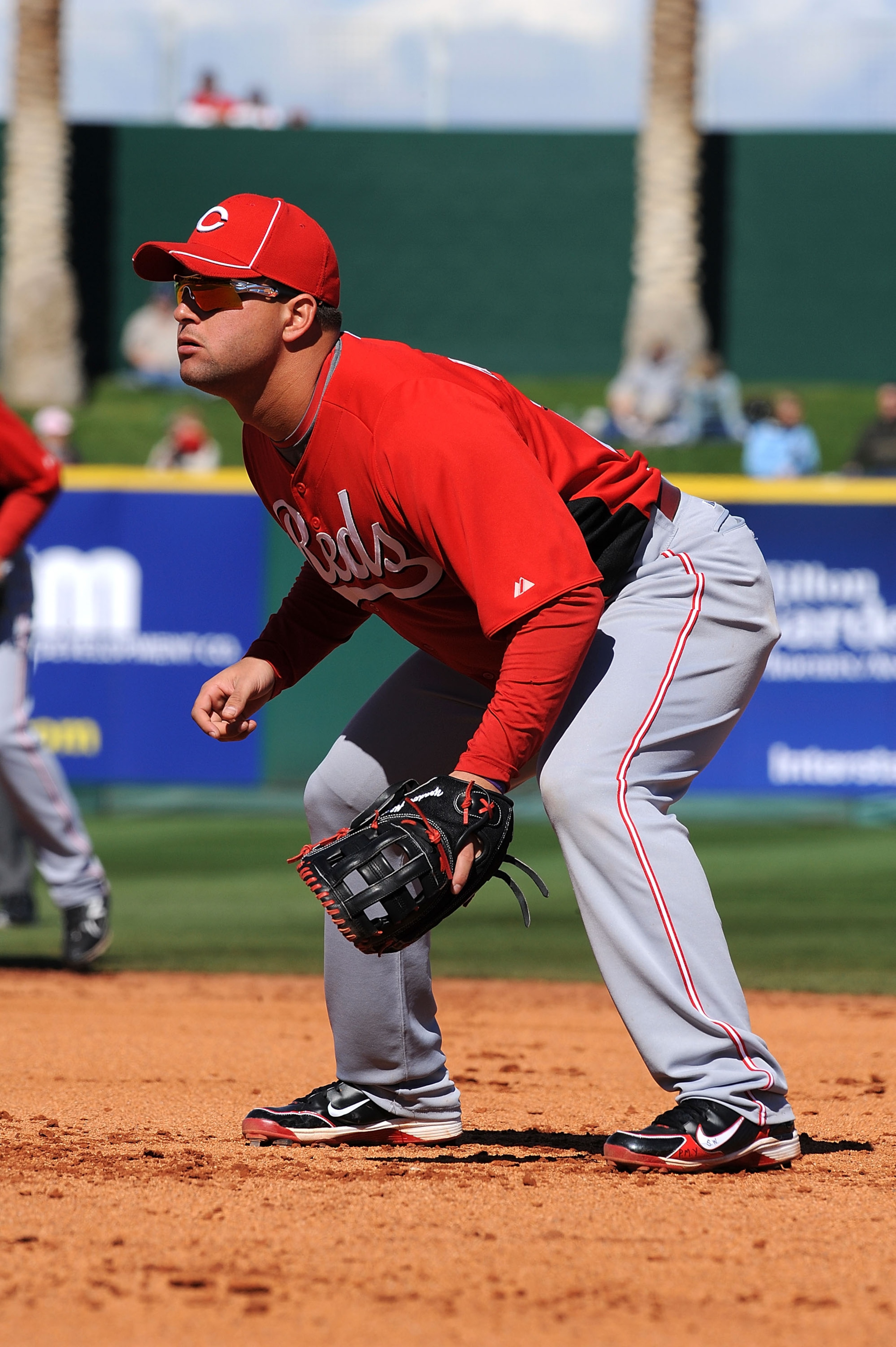 GOODYEAR, AZ - FEBRUARY 27:  Yonder Alonso #23 of the Cincinnati Reds gets ready to make a play at first base against the Cleveland Indians at Goodyear Ballpark on February 27, 2011 in Goodyear, Arizona.  (Photo by Norm Hall/Getty Images)