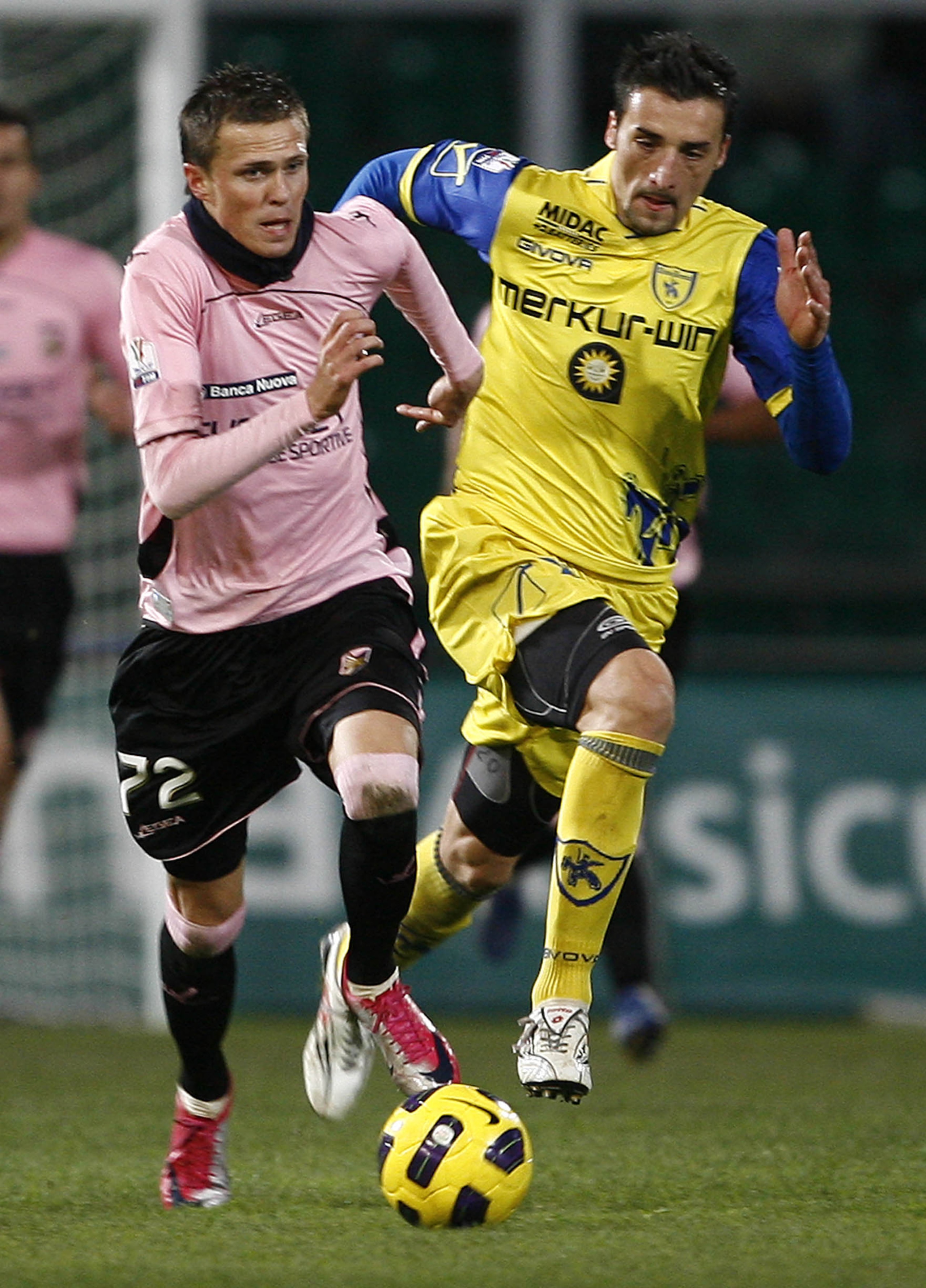 PALERMO, ITALY - JANUARY 12: Josip Ilicic (L) of Palermo and Gennaro Sardo of Palermo compete for the ball during the Tim Cup match between Palermo and Chievo Verona at Stadio Renzo Barbera on January 12, 2011 in Palermo, Italy.  (Photo by Tullio M. Pugli