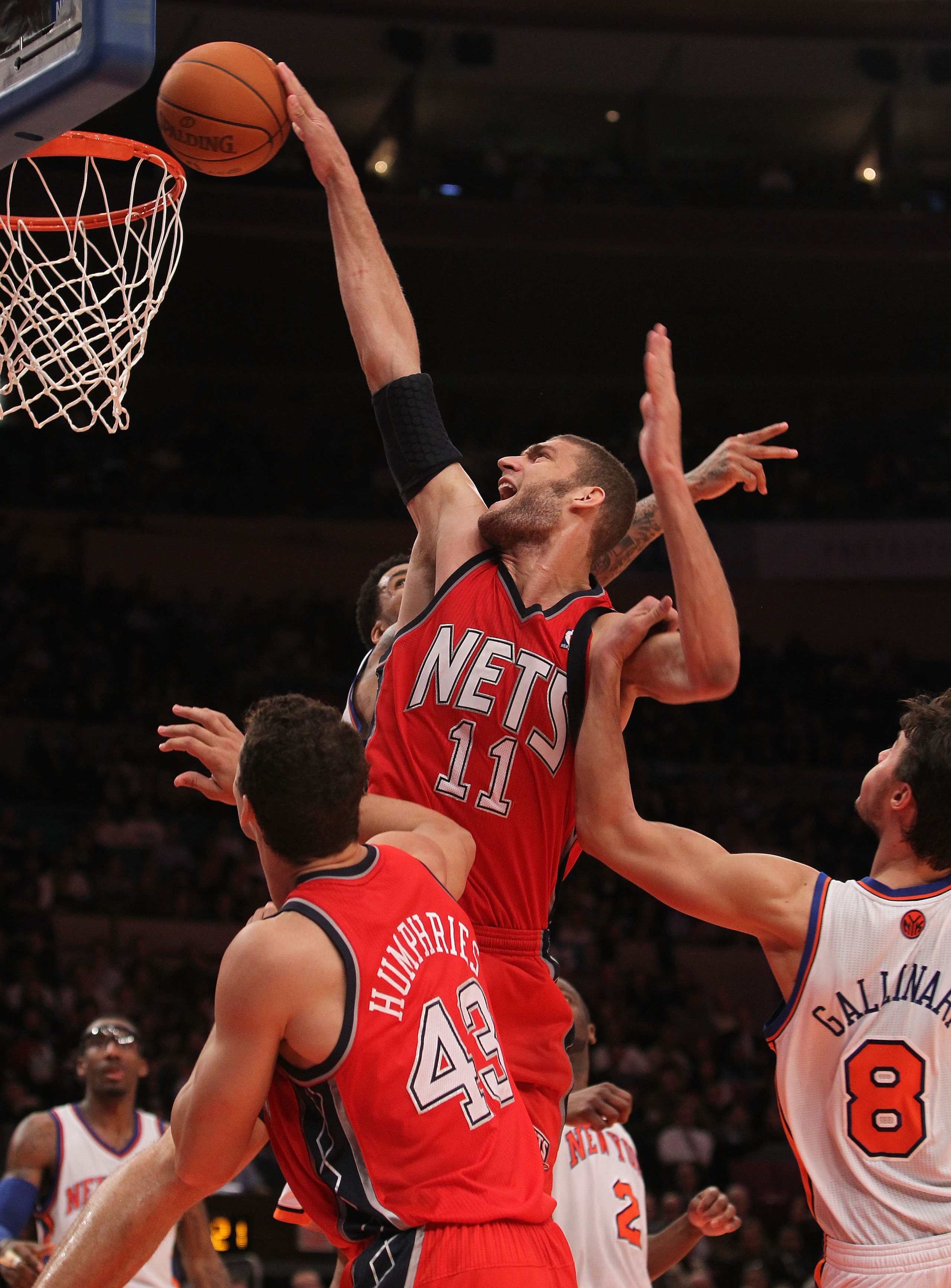 NEW YORK, NY - NOVEMBER 30: Brook Lopez #11 of the of the New Jersey Nets is fouled by Danilo Gallinari #8 of the New York Knicks on November 30, 2010 at Madison Square Garden in New York City. NOTE TO USER: User expressly acknowledges and agrees that, by NEW YORK, NY - NOVEMBER 30: Brook Lopez #11 of the of the New Jersey Nets is fouled by Danilo Gallinari #8 of the New York Knicks on November 30, 2010 at Madison Square Garden in New York City. NOTE TO USER: User expressly acknowledges and agrees that, by