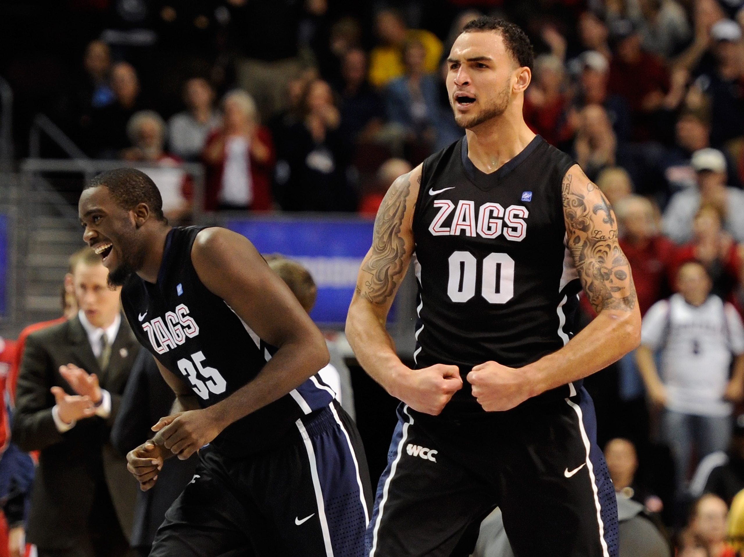 LAS VEGAS, NV - MARCH 07:  Sam Dower #35 and Robert Sacre #00 of the Gonzaga Bulldogs celebrate late in the team's 75-63 victory over the Saint Mary's Gaels in the championship game of the Zappos.com West Coast Conference Basketball tournament at the Orle