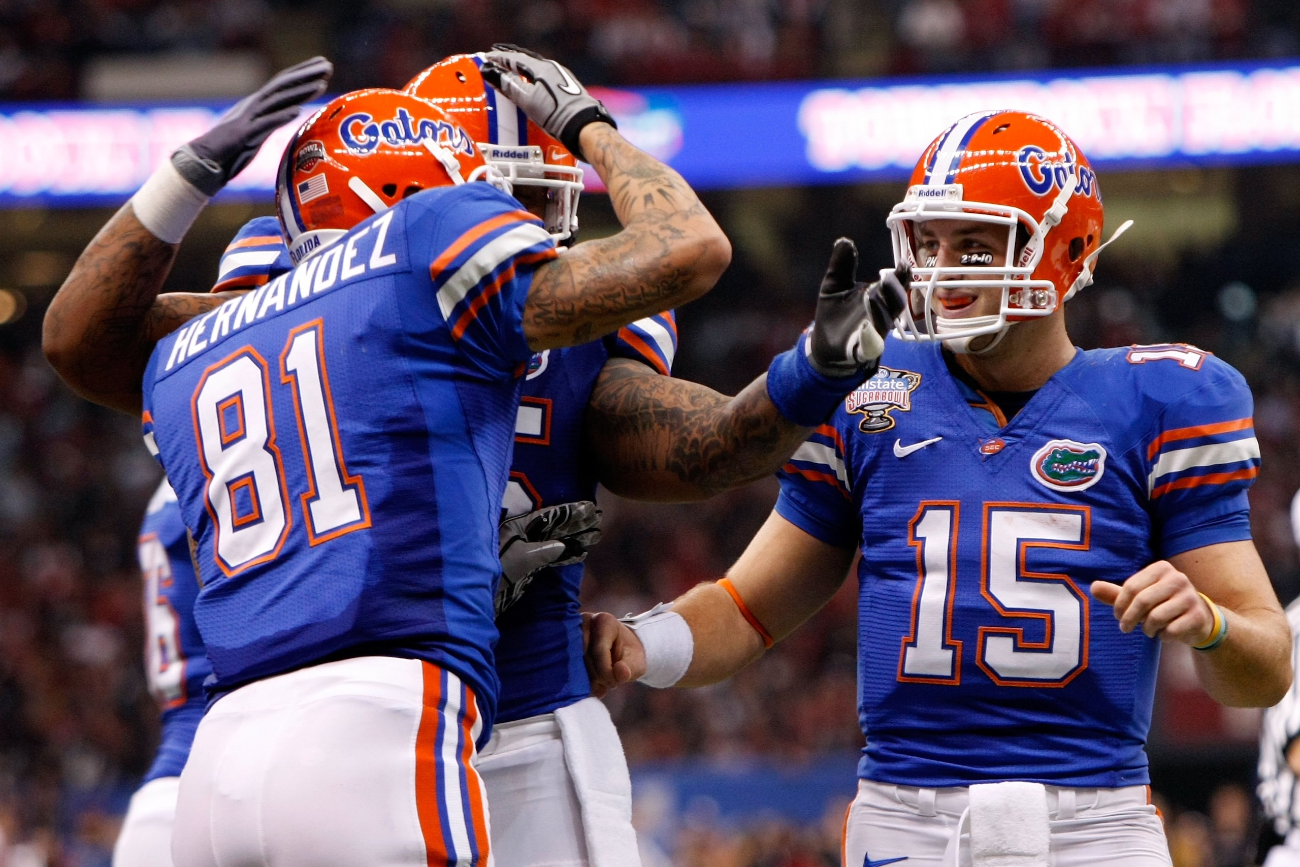 NEW ORLEANS - JANUARY 01:  Aaron Hernandez #81 of the Florida Gators celebrates with his teammates Mike Pouncey #55 and Tim Tebow #15 after scoring a touchdown in the first quarter against the Cincinnati Bearcats during the Allstate Sugar Bowl at the Loui