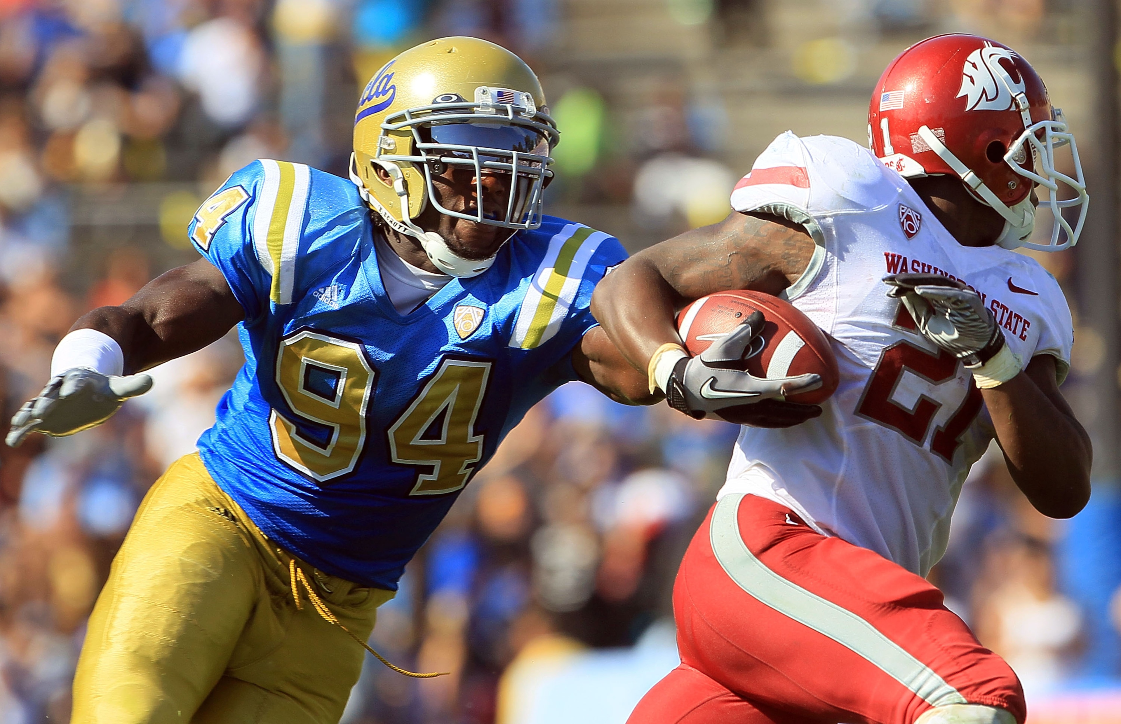PASADENA, CA - OCTOBER 02: Owamagbe Odighizuwa #94 of the UCLA Bruins tries to stop James Montgomery #21 of the Washington State Cougars during the game at the Rose Bowl on October 2, 2010 in Pasadena, California. (Photo by Jeff Gross/Getty Images) PASADENA, CA - OCTOBER 02: Owamagbe Odighizuwa #94 of the UCLA Bruins tries to stop James Montgomery #21 of the Washington State Cougars during the game at the Rose Bowl on October 2, 2010 in Pasadena, California. (Photo by Jeff Gross/Getty Images)