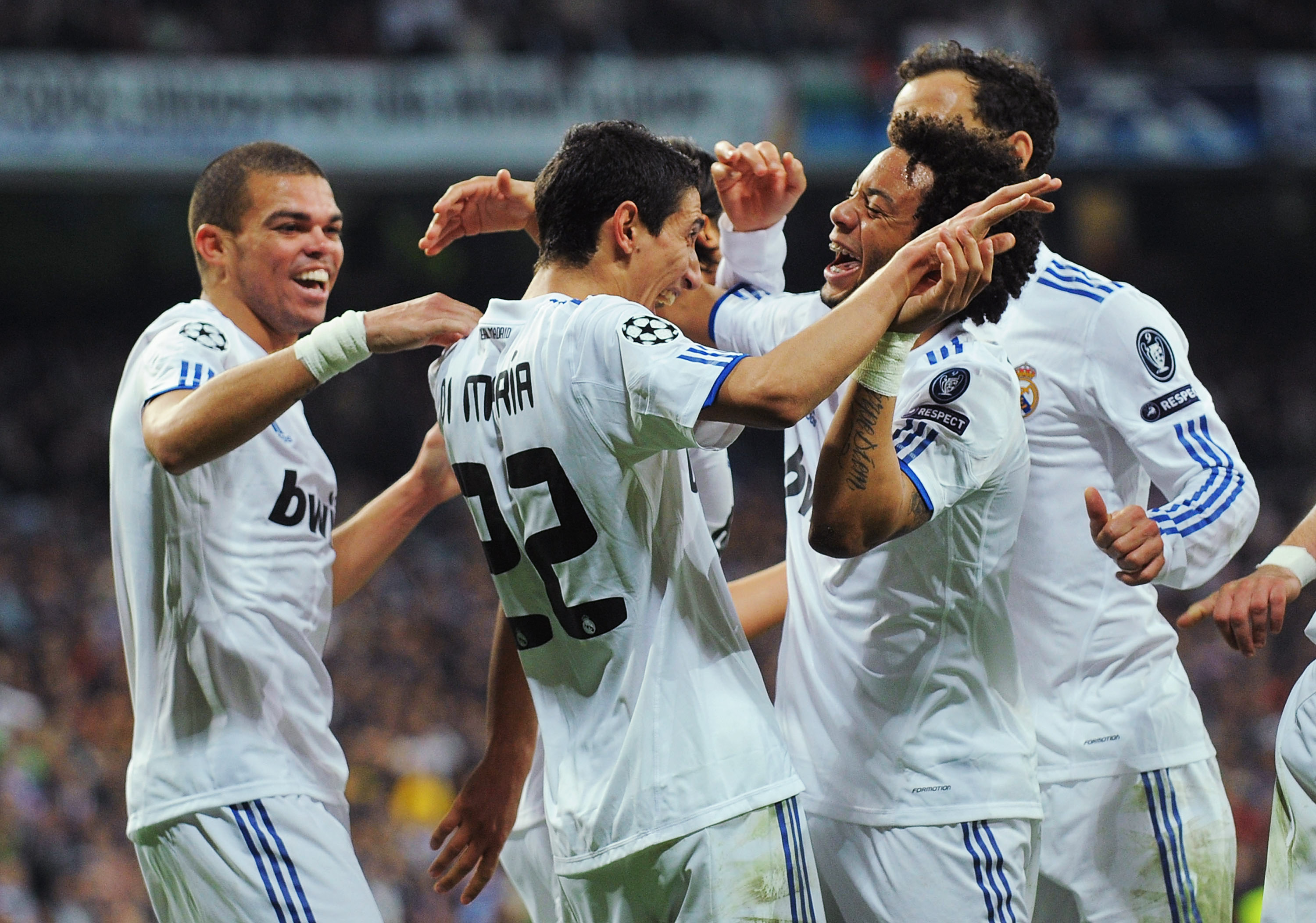 MADRID, SPAIN - MARCH 16:  Angel Di Maria (L) of Real Madrid celebrates with Marcelo after scoring Real's third goal during the UEFA Champions League round of 16 second leg match between Real Madrid and Lyon at Estadio Santiago Bernabeu on March 16, 2011
