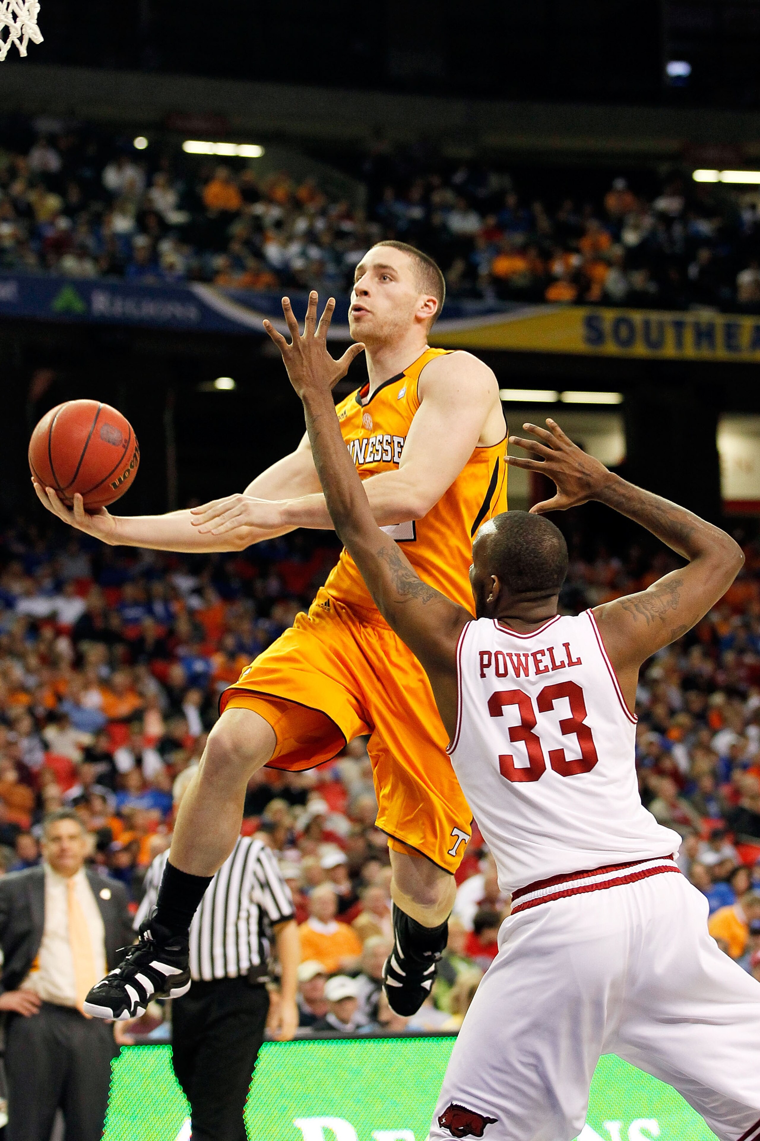 ATLANTA, GA - MARCH 10:  Steven Pearl #22 of the Tennessee Volunteers shoots against Marshawn Powell #33 of the Arkansas Razorbacks during the first round of the SEC Men's Basketball Tournament at the Georgia Dome on March 10, 2011 in Atlanta, Georgia.  (