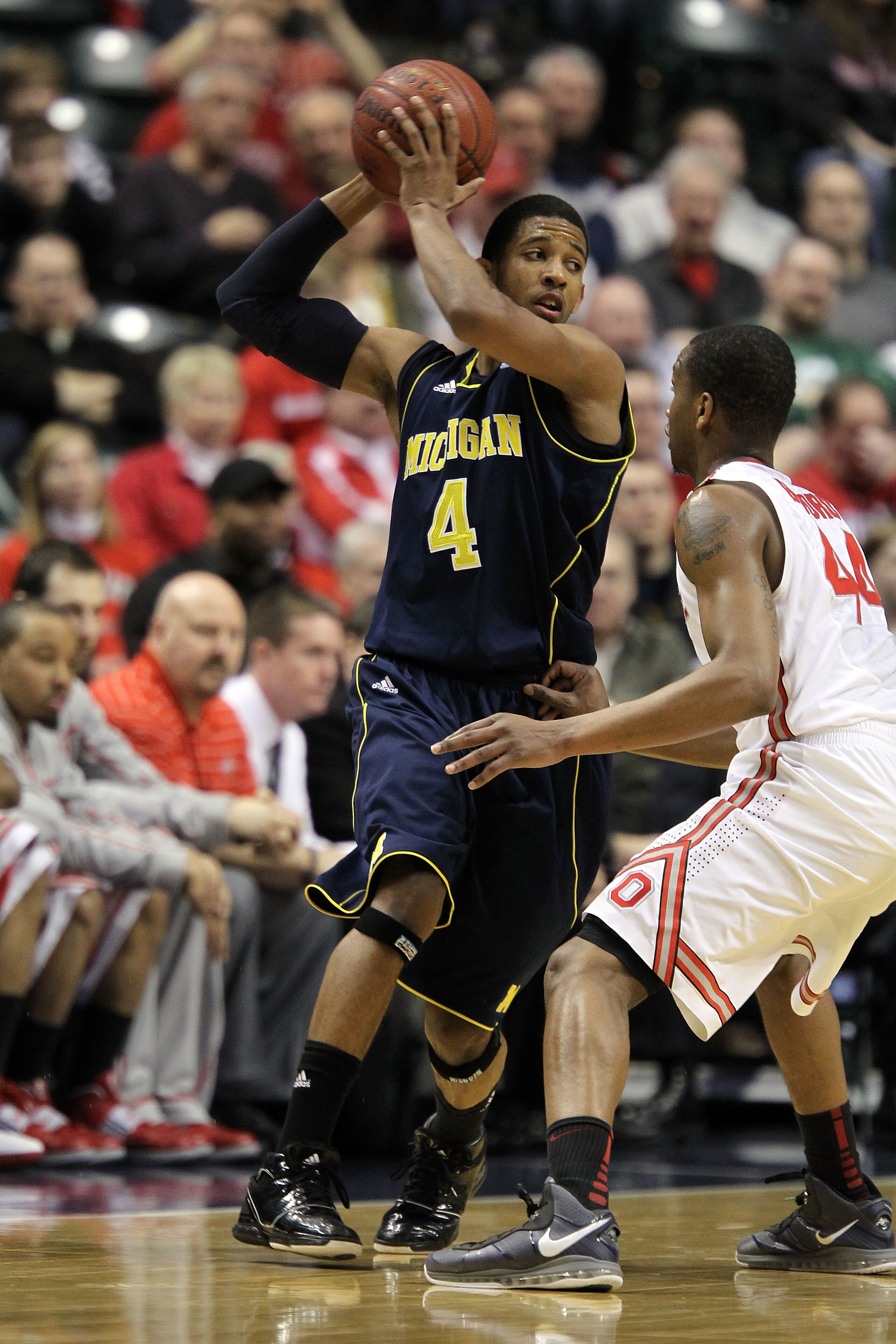 INDIANAPOLIS, IN - MARCH 12:  Darius Morris #4 of the Michigan Wolverines looks to pass the ball against the Ohio State Buckeyes during the semifinals of the 2011 Big Ten Men's Basketball Tournament at Conseco Fieldhouse on March 12, 2011 in Indianapolis,