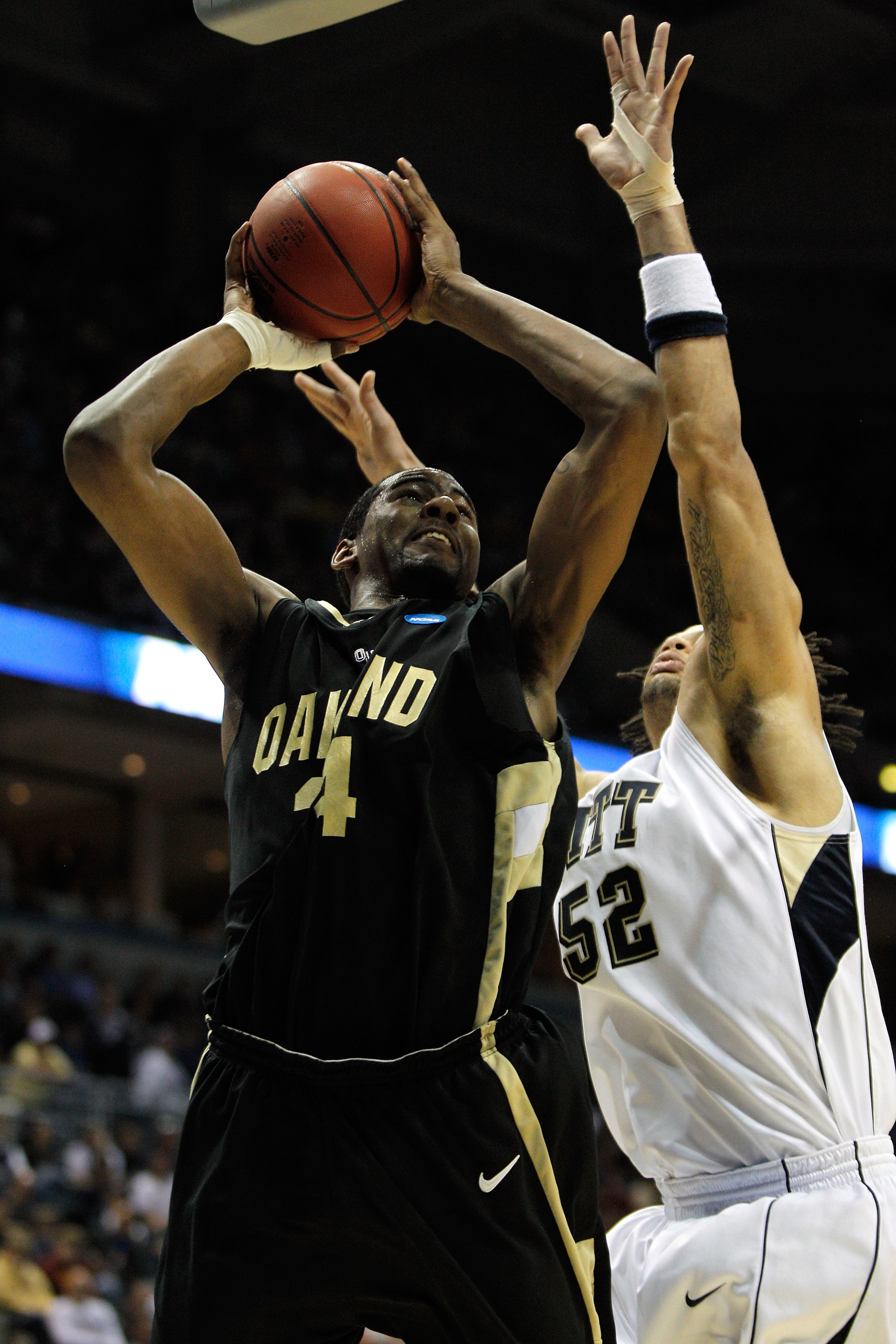 MILWAUKEE - MARCH 19:  Keith Benson #34 of the Oakland Golden Grizzlies shoots the ball over Gary McGhee #52 of the Pittsburgh Panthers in the first half during the first round of the 2010 NCAA men's basketball tournament at the Bradley Center on March 19