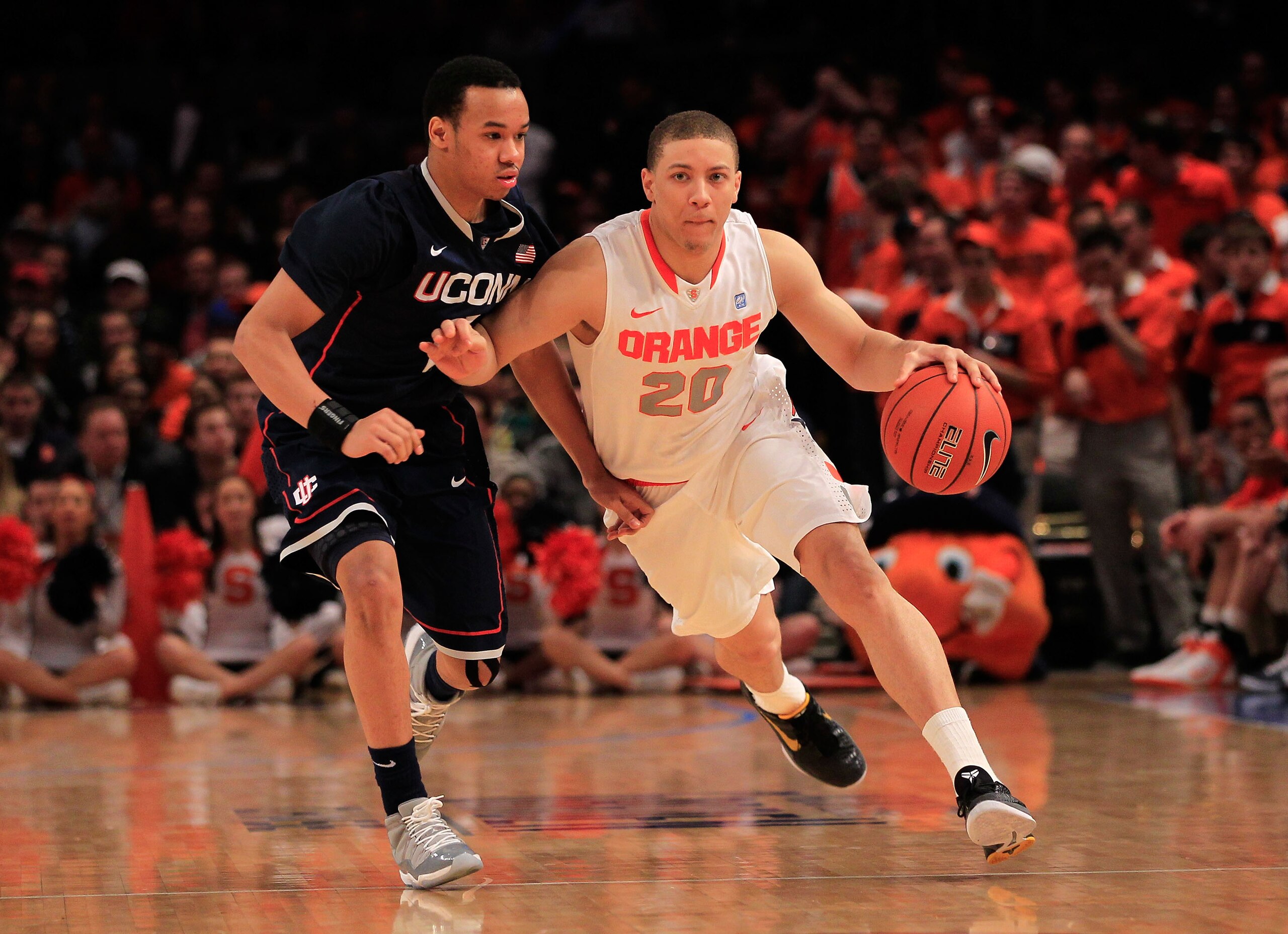 NEW YORK, NY - MARCH 11: Brandon Triche #20 of the Syracuse Orange drives with the ball against Shabazz Napier #13 of the Connecticut Huskies during the semifinals of the 2011 Big East Men's Basketball Tournament presented by American Eagle Outfitters at NEW YORK, NY - MARCH 11: Brandon Triche #20 of the Syracuse Orange drives with the ball against Shabazz Napier #13 of the Connecticut Huskies during the semifinals of the 2011 Big East Men's Basketball Tournament presented by American Eagle Outfitters at
