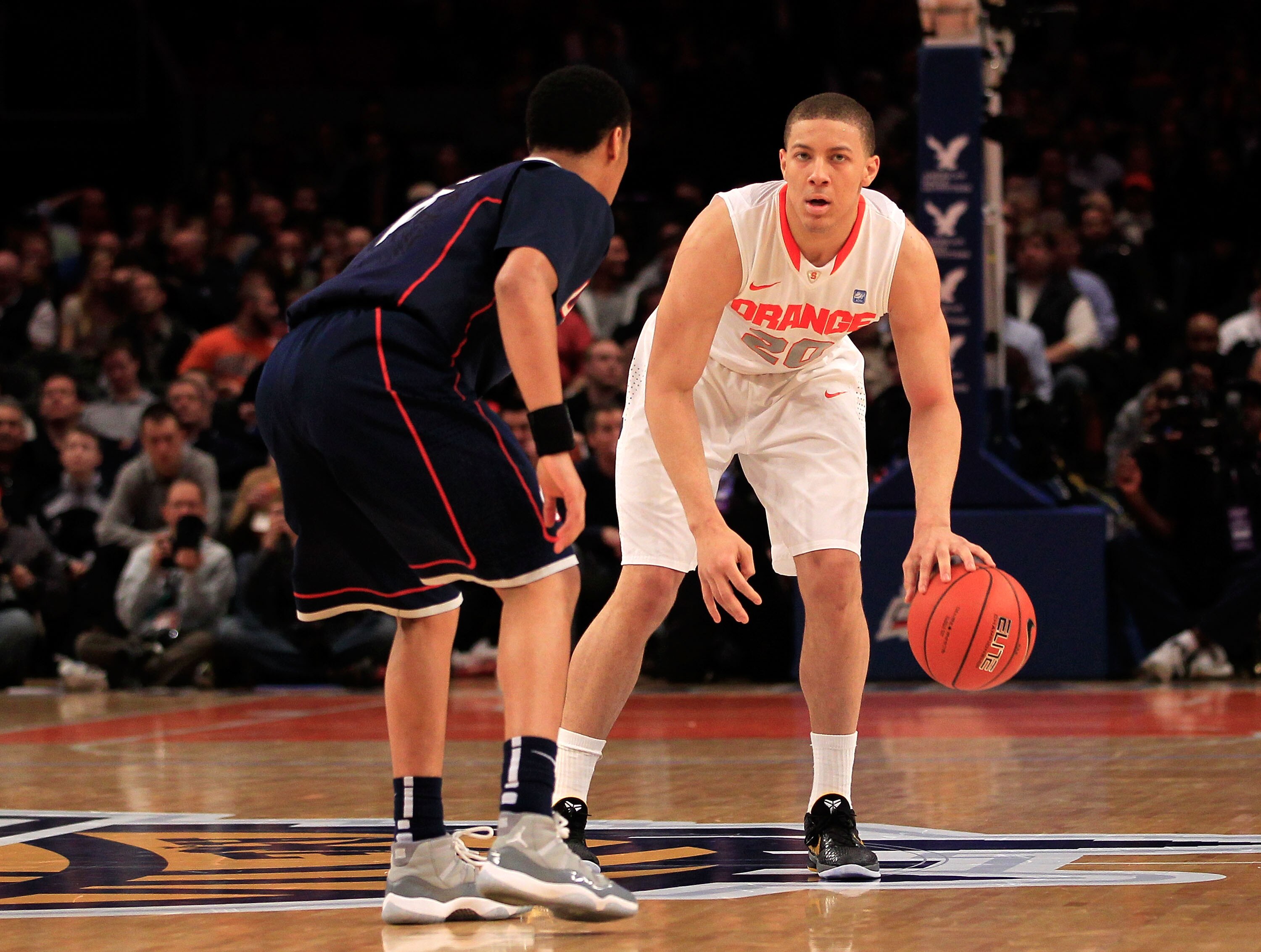 NEW YORK, NY - MARCH 11:  Brandon Triche #20 of the Syracuse Orange brings the ball up court against Shabazz Napier #13 of the Connecticut Huskies during the semifinals of the 2011 Big East Men's Basketball Tournament presented by American Eagle Outfitter
