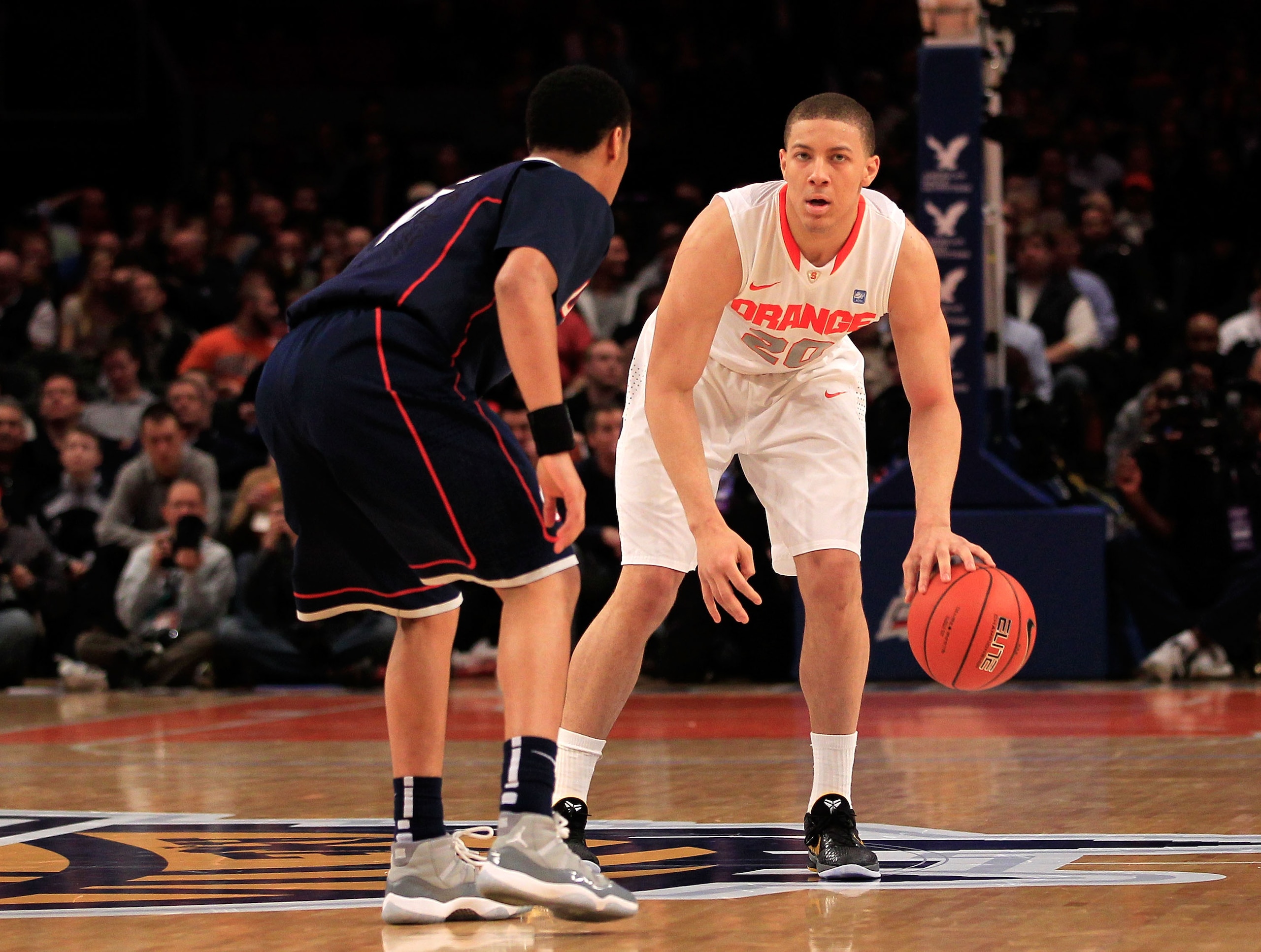 NEW YORK, NY - MARCH 11: Brandon Triche #20 of the Syracuse Orange brings the ball up court against Shabazz Napier #13 of the Connecticut Huskies during the semifinals of the 2011 Big East Men's Basketball Tournament presented by American Eagle Outfitter NEW YORK, NY - MARCH 11: Brandon Triche #20 of the Syracuse Orange brings the ball up court against Shabazz Napier #13 of the Connecticut Huskies during the semifinals of the 2011 Big East Men's Basketball Tournament presented by American Eagle Outfitter