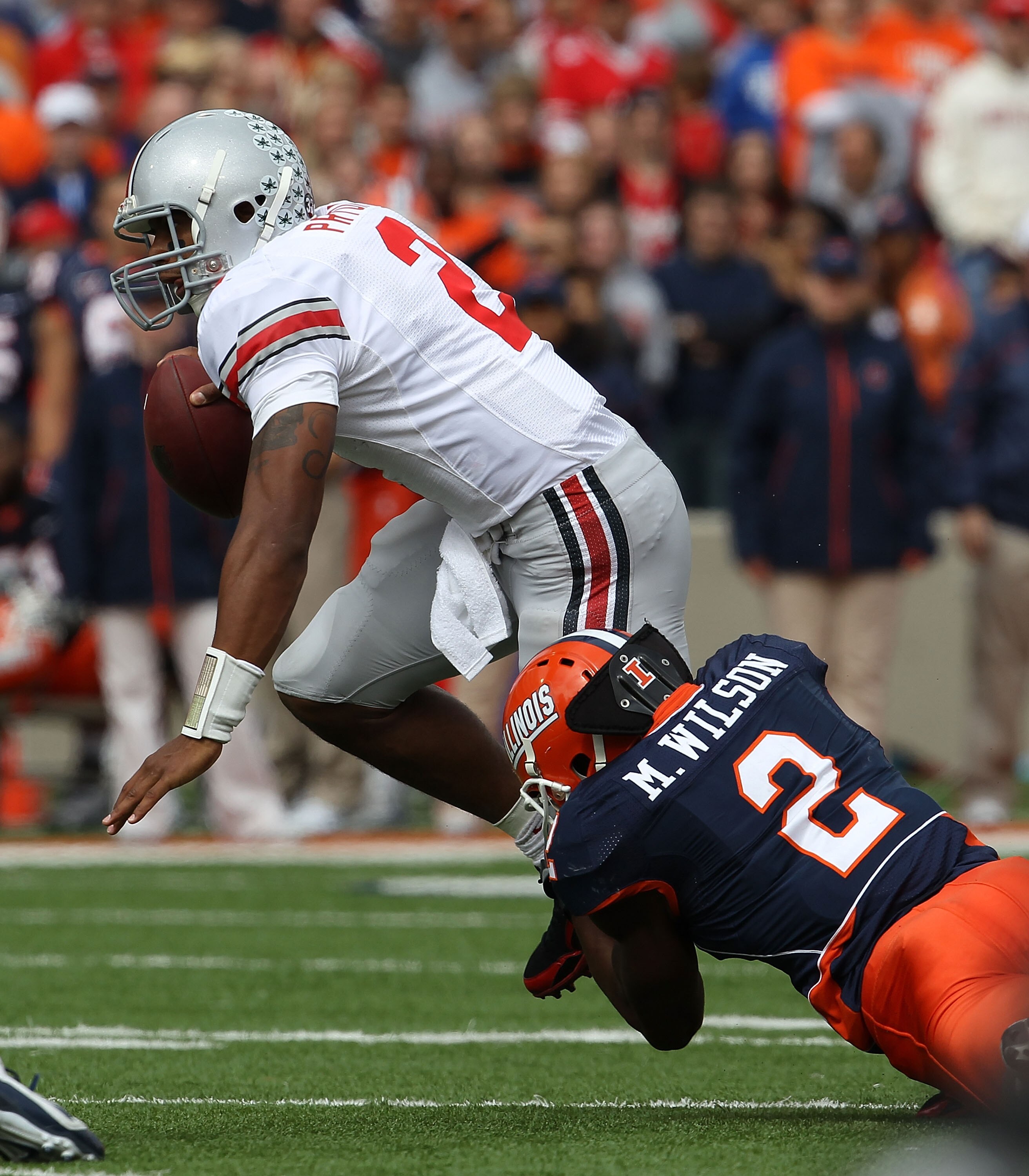 CHAMPAIGN, IL - OCTOBER 02: Terrelle Pryor #2 of the Ohio State Buckeyes is brought down by Martez Wilson #2 of the Illinois Fighting Illini at Memorial Stadium on October 2, 2010 in Champaign, Illinois. Ohio State defeated Illinois 24-13. (Photo by Jonat