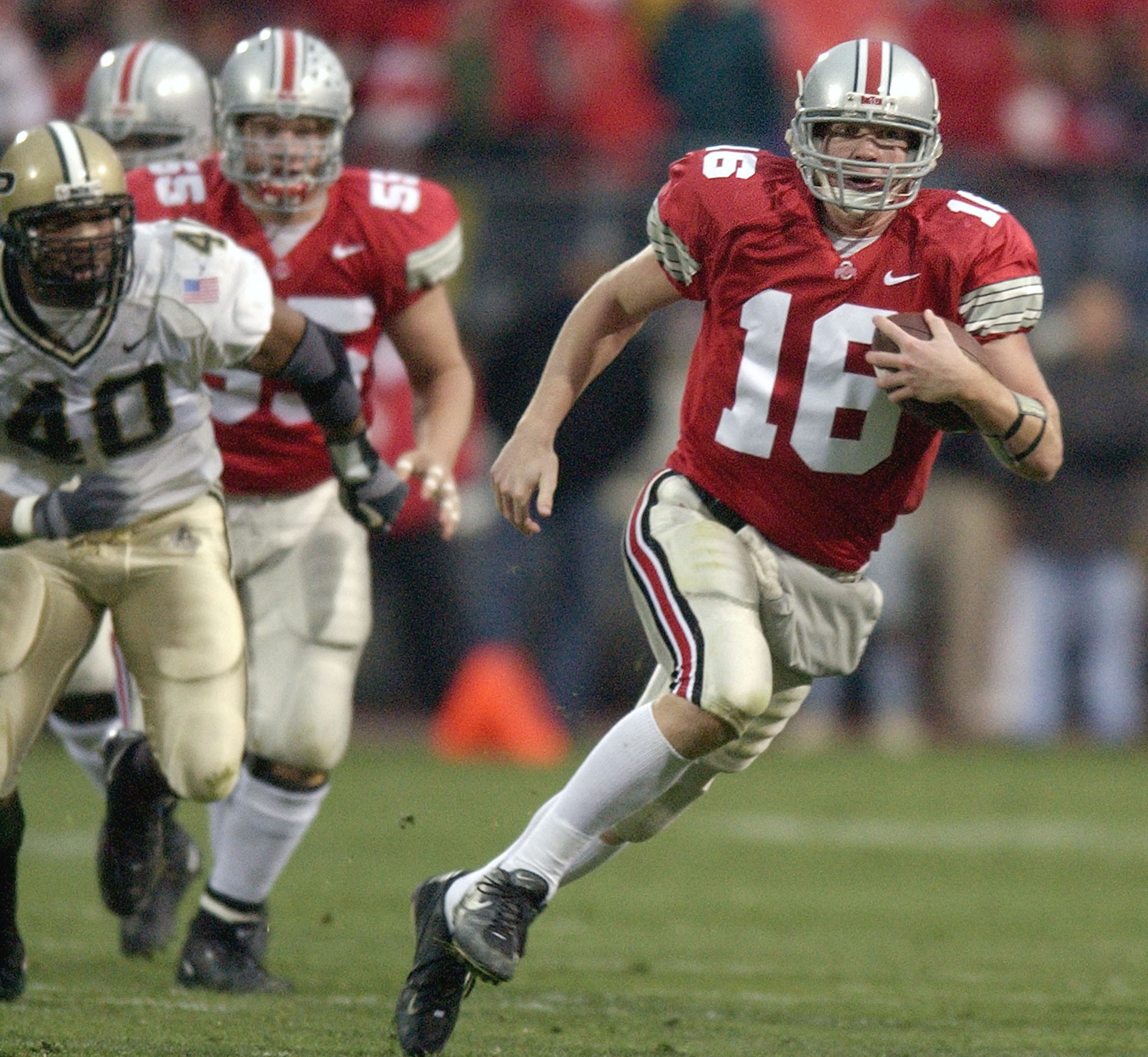 COLUMBUS, OH - NOVEMBER 15:  Quarterback Craig Krenzel #16 of the Ohio State Buckeyes carries the ball for a first down against the Purdue Boilermakers during the second quarter on November 15, 2003 at Ohio Stadium in Columbus, Ohio. Ohio State defeated P