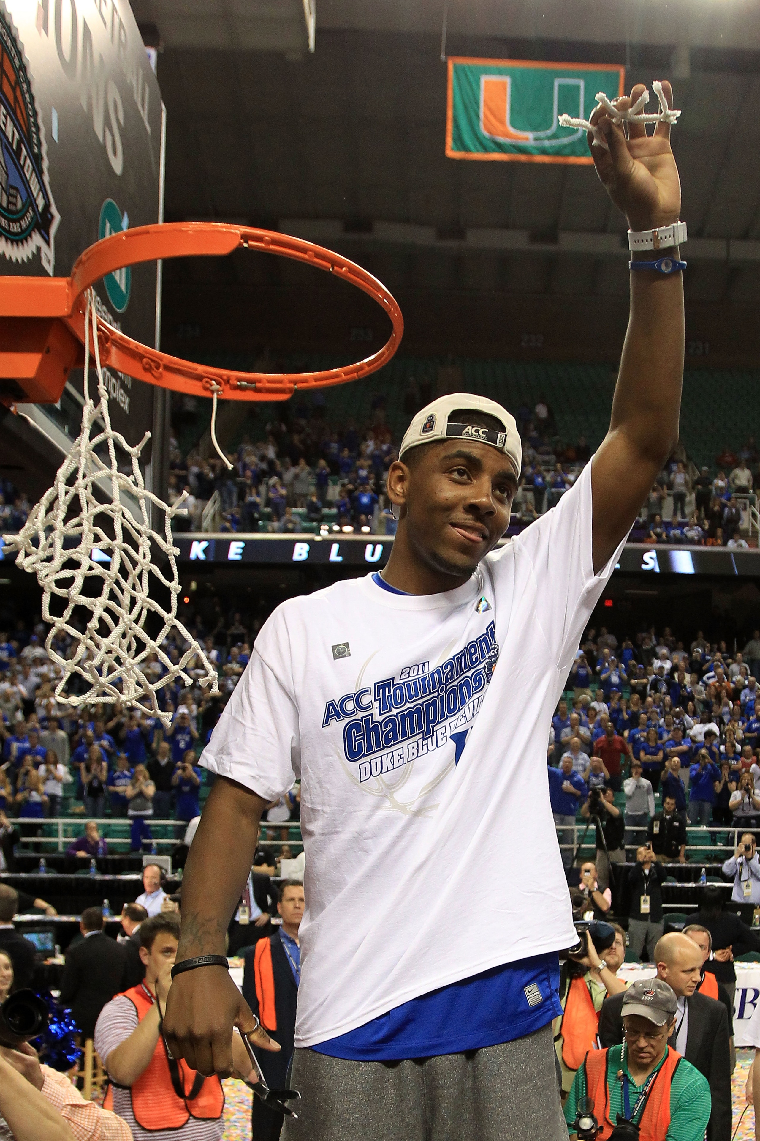 GREENSBORO, NC - MARCH 13:  Kyrie Irving #1 of the Duke Blue Devils cuts down the net after defeating the North Carolina Tar Heels 75-58 in the championship game of the 2011 ACC men's basketball tournament at the Greensboro Coliseum on March 13, 2011 in G