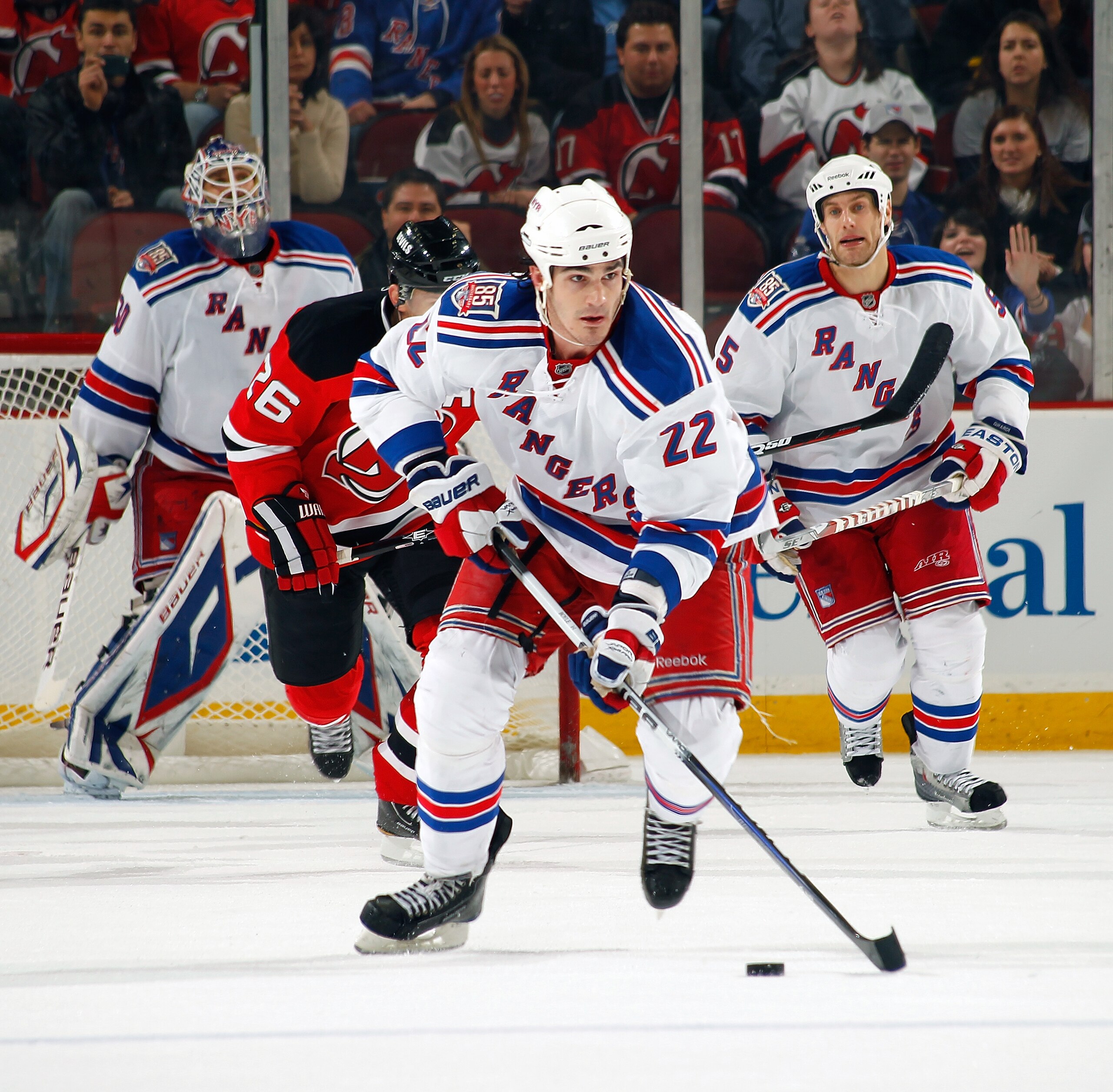 NEWARK, NJ - DECEMBER 29:  Brian Boyle #22 of the New York Rangers skates with the puck against New Jersey Devils during a game on December 29, 2010 at the Prudential Center in Newark, New Jersey. The Rangers won 3-1.  (Photo by Lou Capozzola/Getty Images