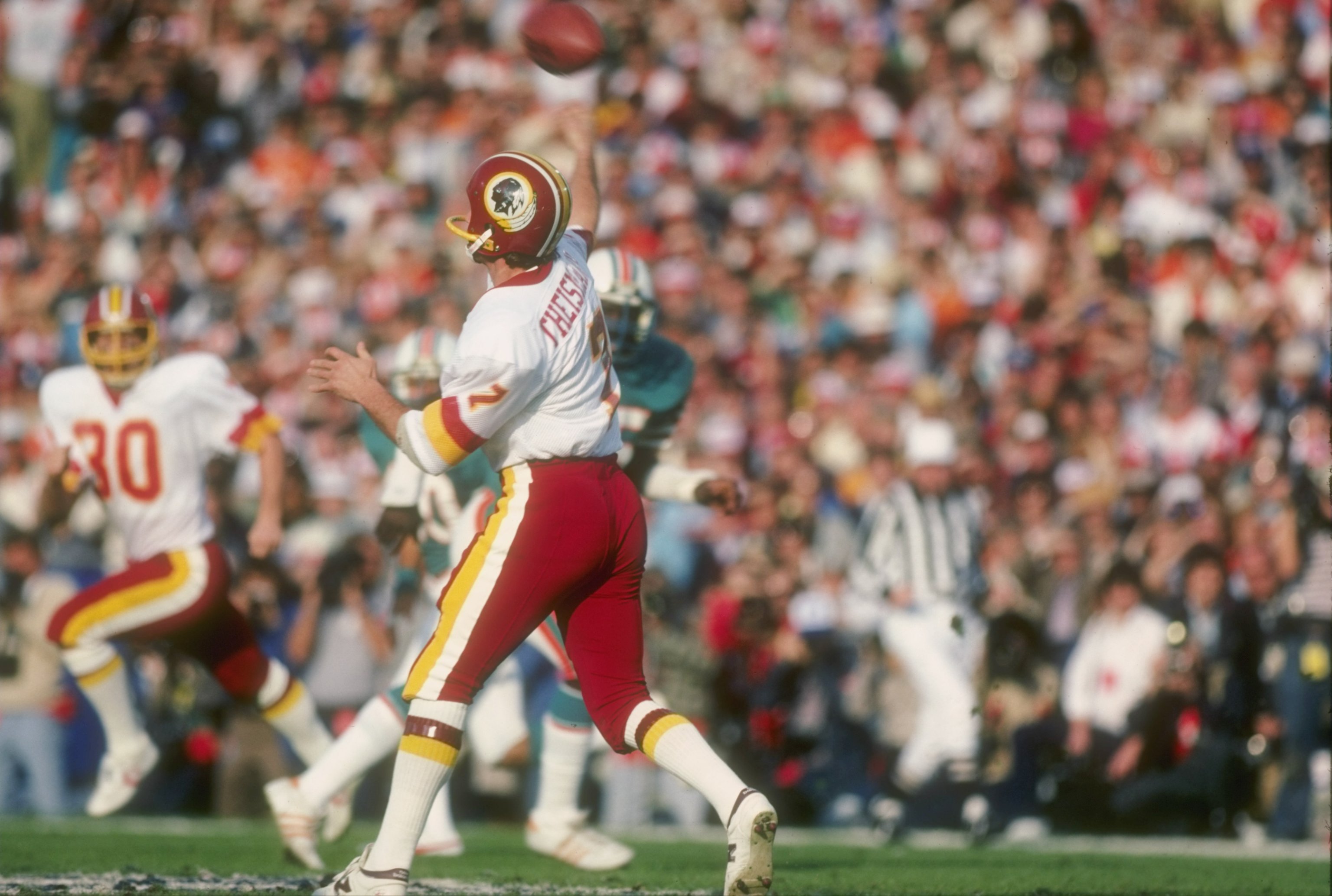 Washington Redskins quarterback Joe Theismann (7) gets ready to throw a  pass down field against the