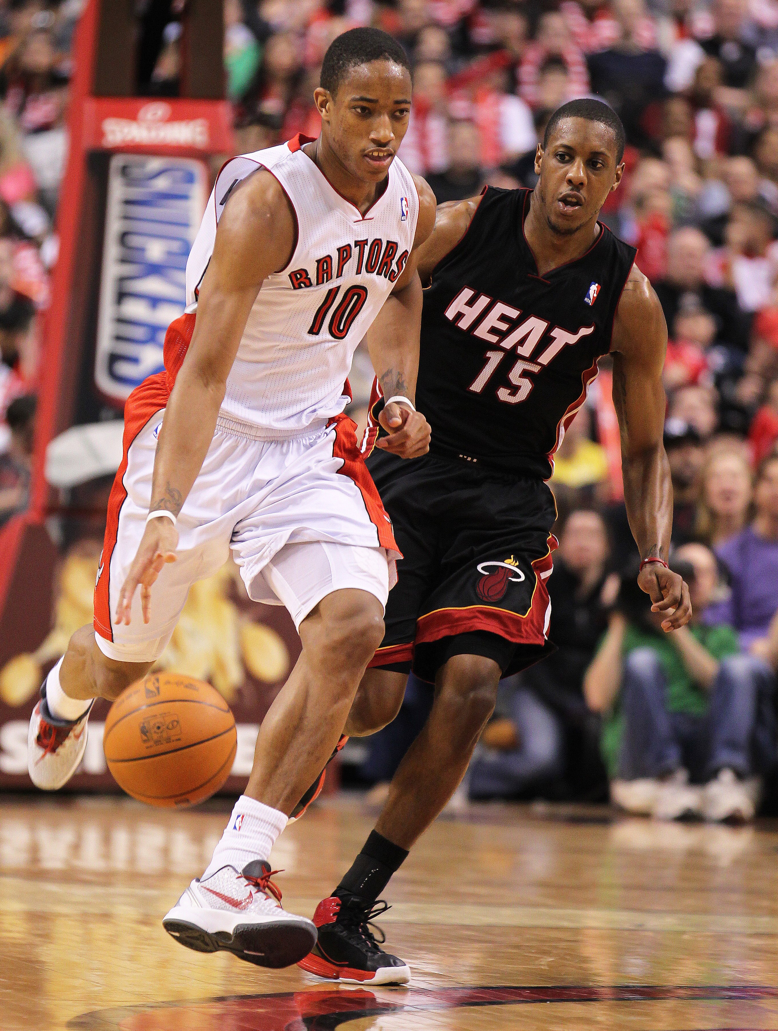 TORONTO, CANADA - FEBRUARY 16:  DeMar DeRozan #10 of the Toronto Raptors drives back up court while being covered by Mario Chalmers #15 of the Miami Heat in a game on February 16, 2011 at the Air Canada Centre in Toronto, Canada. The Heat defeated the Rap