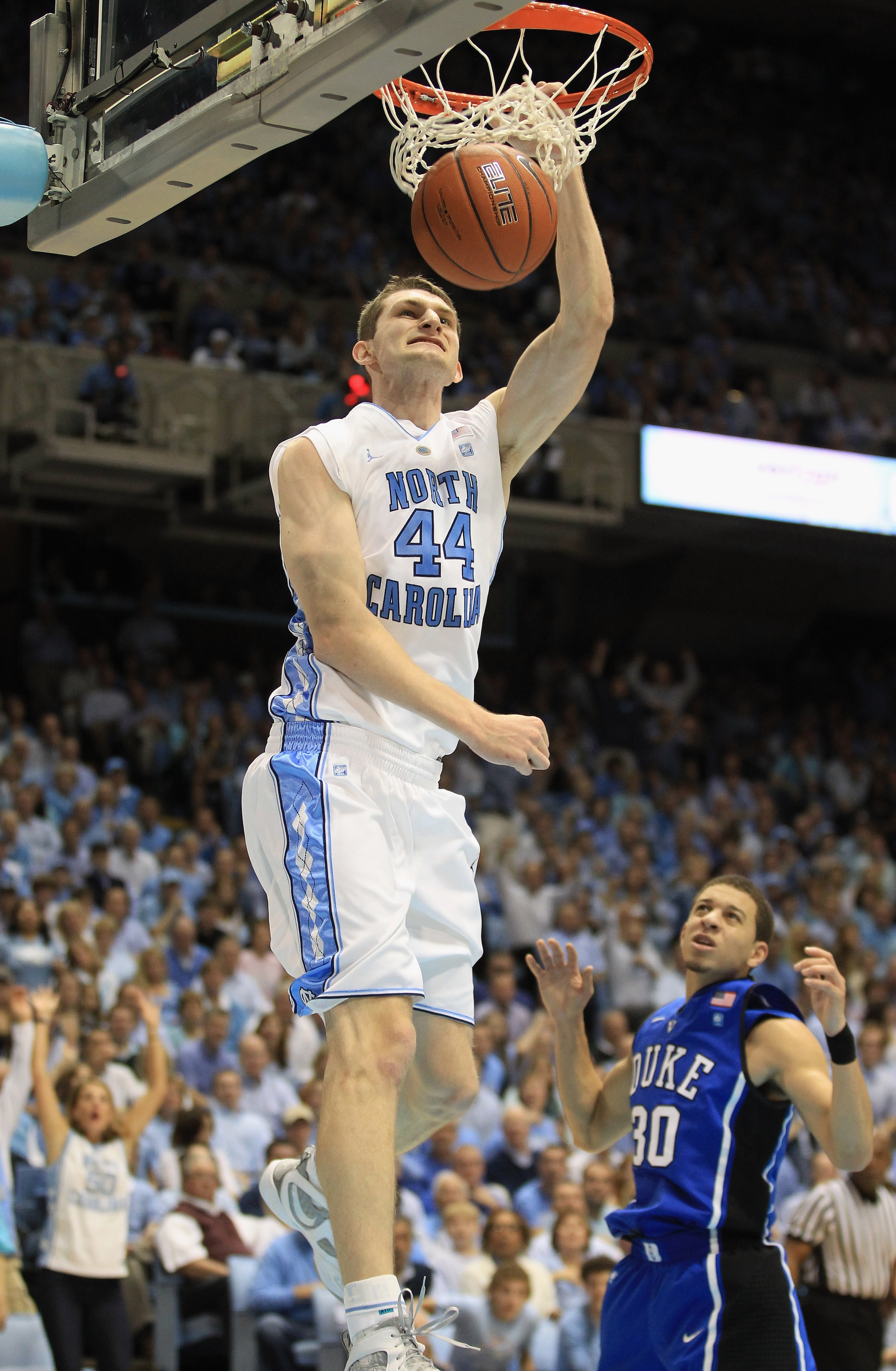 CHAPEL HILL, NC - MARCH 05:  Seth Curry #30 of the Duke Blue Devils watches as Tyler Zeller #44 of the North Carolina Tar Heels dunks the ball during their game at the Dean E. Smith Center on March 5, 2011 in Chapel Hill, North Carolina.  (Photo by Street