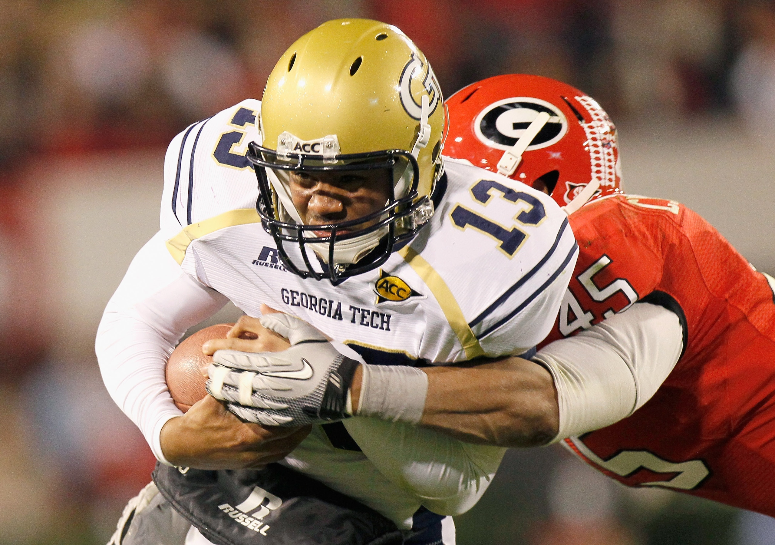 ATHENS, GA - NOVEMBER 27:  Quarterback Tevin Washington #13 of the Georgia Tech Yellow Jackets is tackled by Christian Robinson #45 the Georgia Bulldogs at Sanford Stadium on November 27, 2010 in Athens, Georgia.  (Photo by Kevin C. Cox/Getty Images)