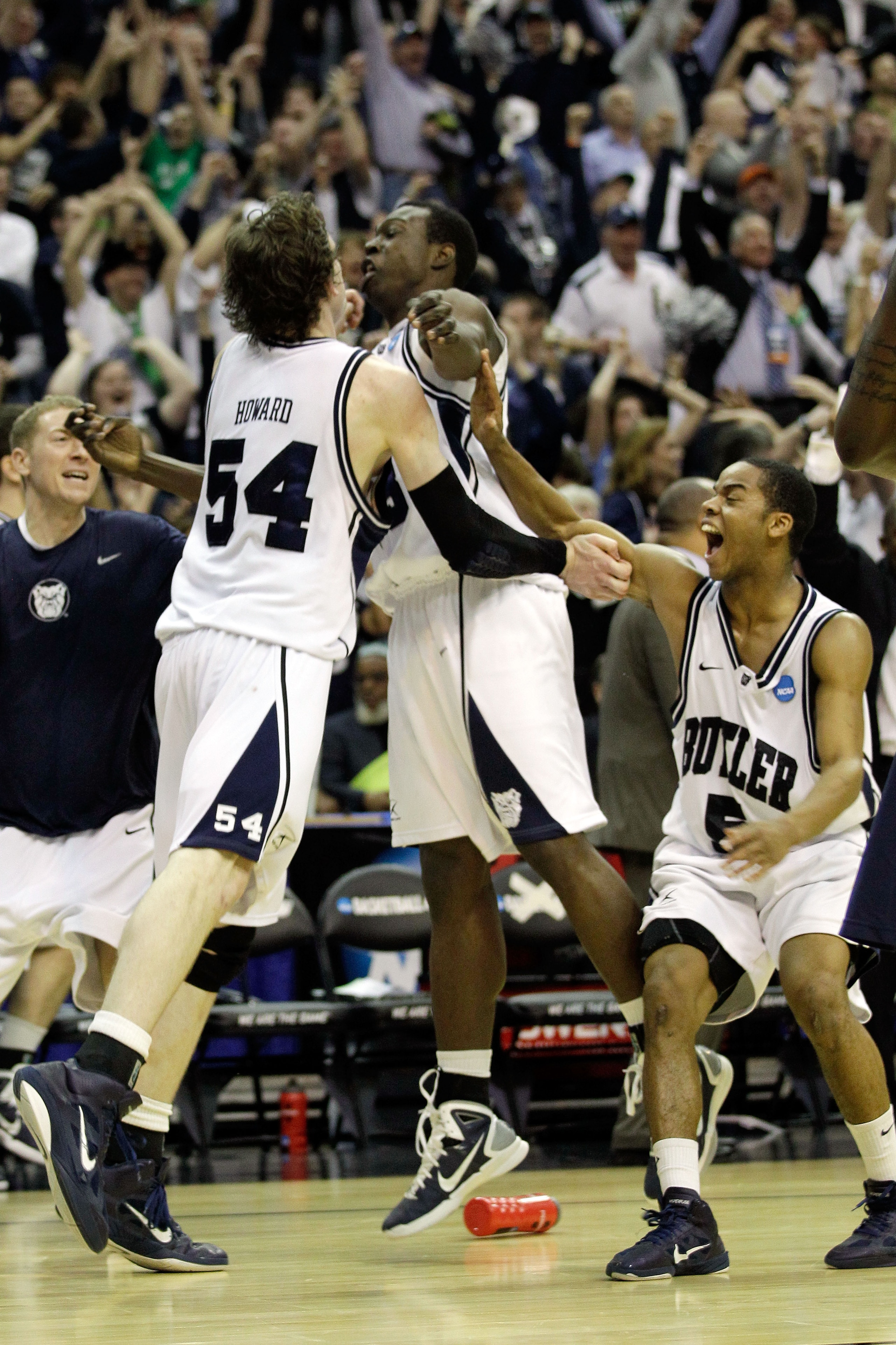 WASHINGTON - MARCH 17:  Matt Howard #54, Khyle Marshall #23, and Ronald Nored #5 of the Butler Bulldogs celebrate their 60-58 win over the Old Dominion Monarchs during the second round of the 2011 NCAA men's basketball tournament at the Verizon Center on