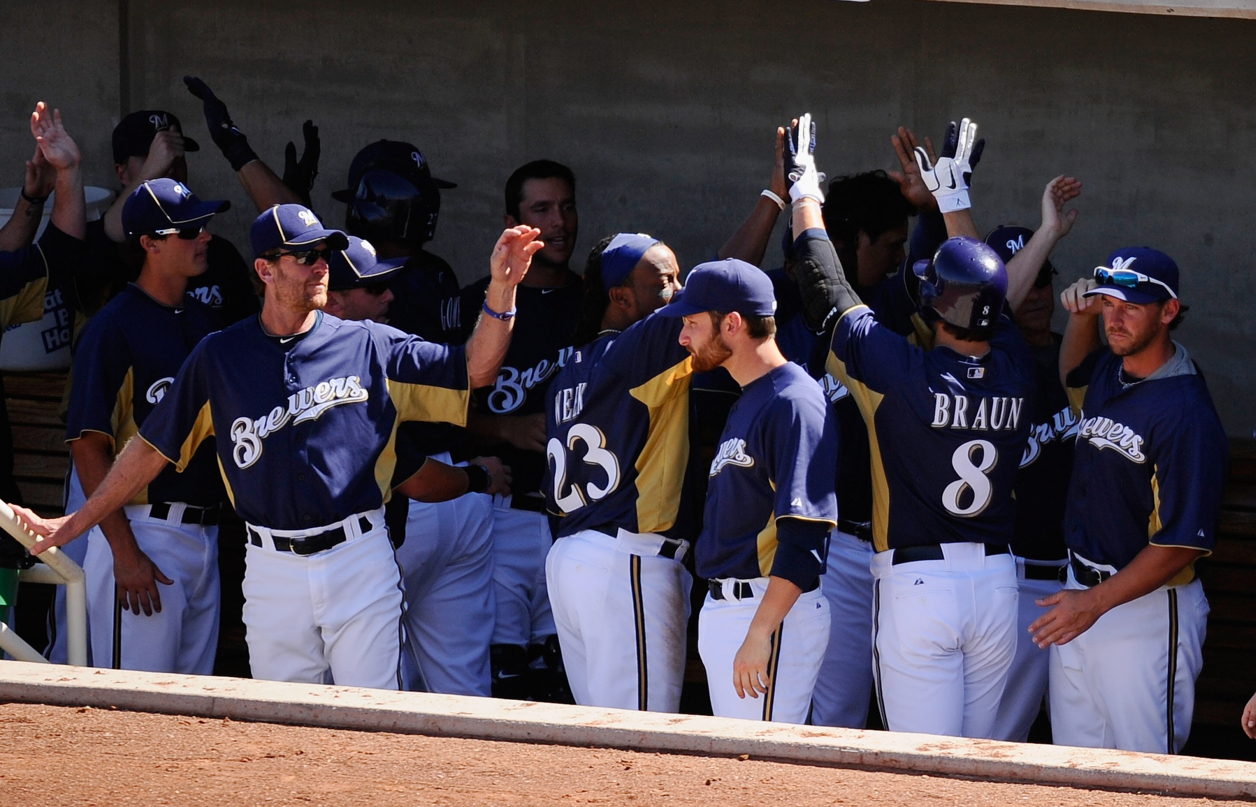 PHOENIX, AZ - MARCH 10: Ryan Braun #8 of the Milwaukee Brewers is congratulated by teammates after hitting a three-run home run against the Colorado Rockies in the third inning of the spring training baseball game at Maryvale Baseball Park on March 10, 2 PHOENIX, AZ - MARCH 10: Ryan Braun #8 of the Milwaukee Brewers is congratulated by teammates after hitting a three-run home run against the Colorado Rockies in the third inning of the spring training baseball game at Maryvale Baseball Park on March 10, 2