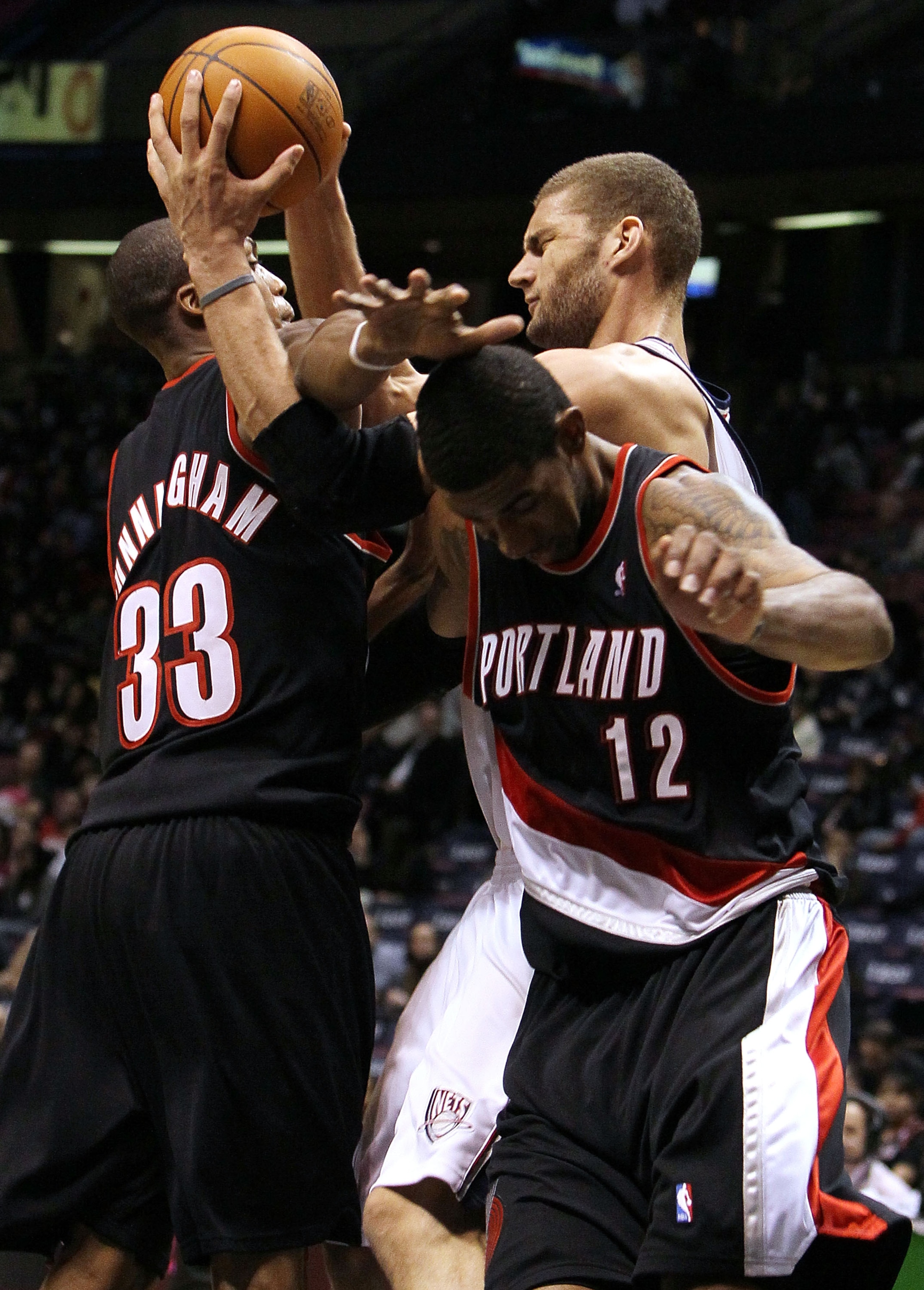 EAST RUTHERFORD, NJ - FEBRUARY 23:  Brook Lopez #11 of the New Jersey Nets fights for a loose ball against LaMarcus Aldridge #12 and Dante Cunningham #33 of the Portland Trail Blazers at the Izod Center on February 23, 2010 in East Rutherford, New Jersey.