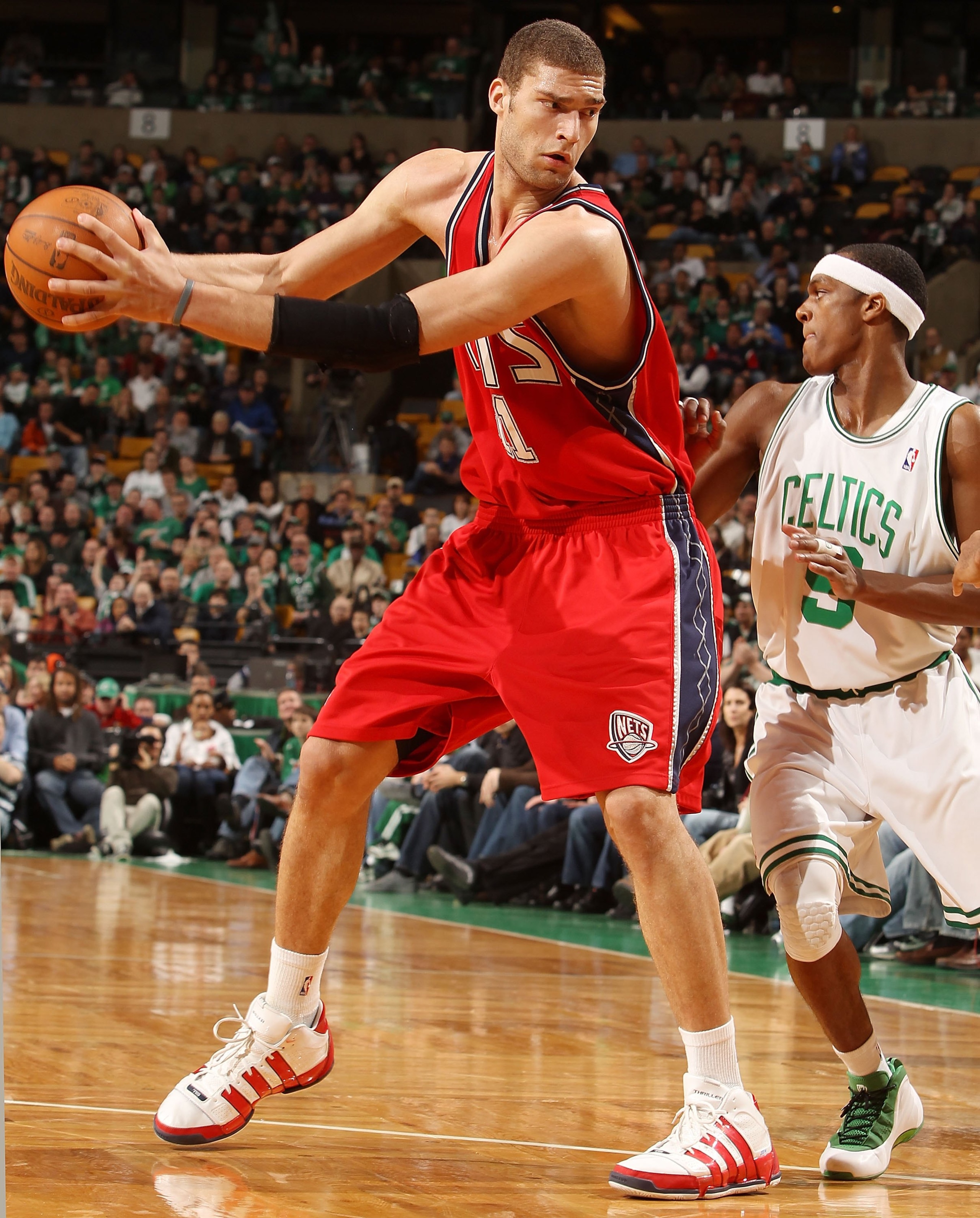 BOSTON - FEBRUARY 27:  Brook Lopez #11 of the New Jersey Nets looks to pass as Rajon Rondo #9  of the Boston Celtics defends at the TD Garden on February 27, 2010 in Boston, Massachusetts. The Nets defeated the Celtics 104-96.  NOTE TO USER: User expressl